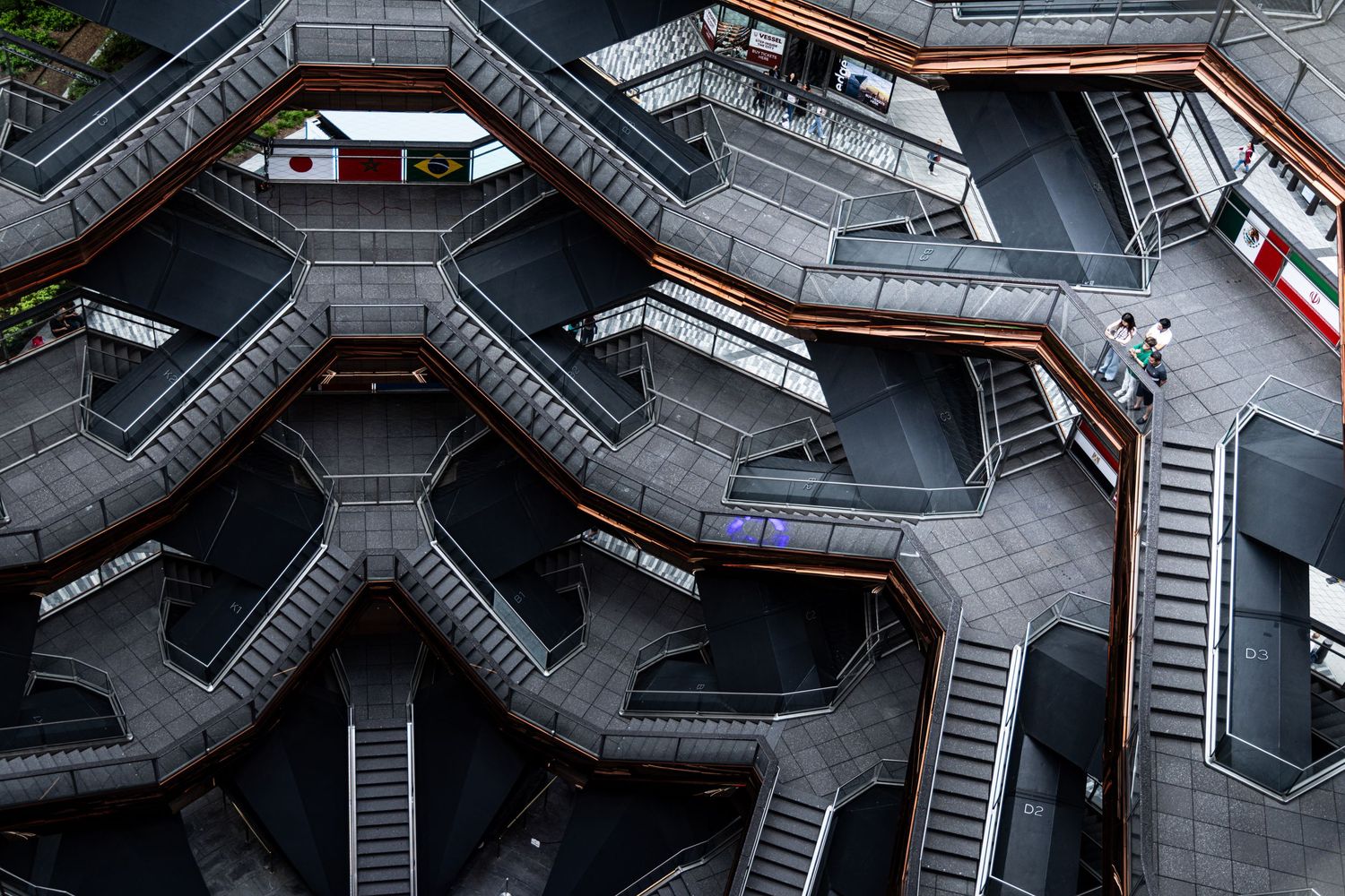 Aerial view of The Vessel at Hudson Yards, NYC, showcasing its intricate honeycomb staircase structure.