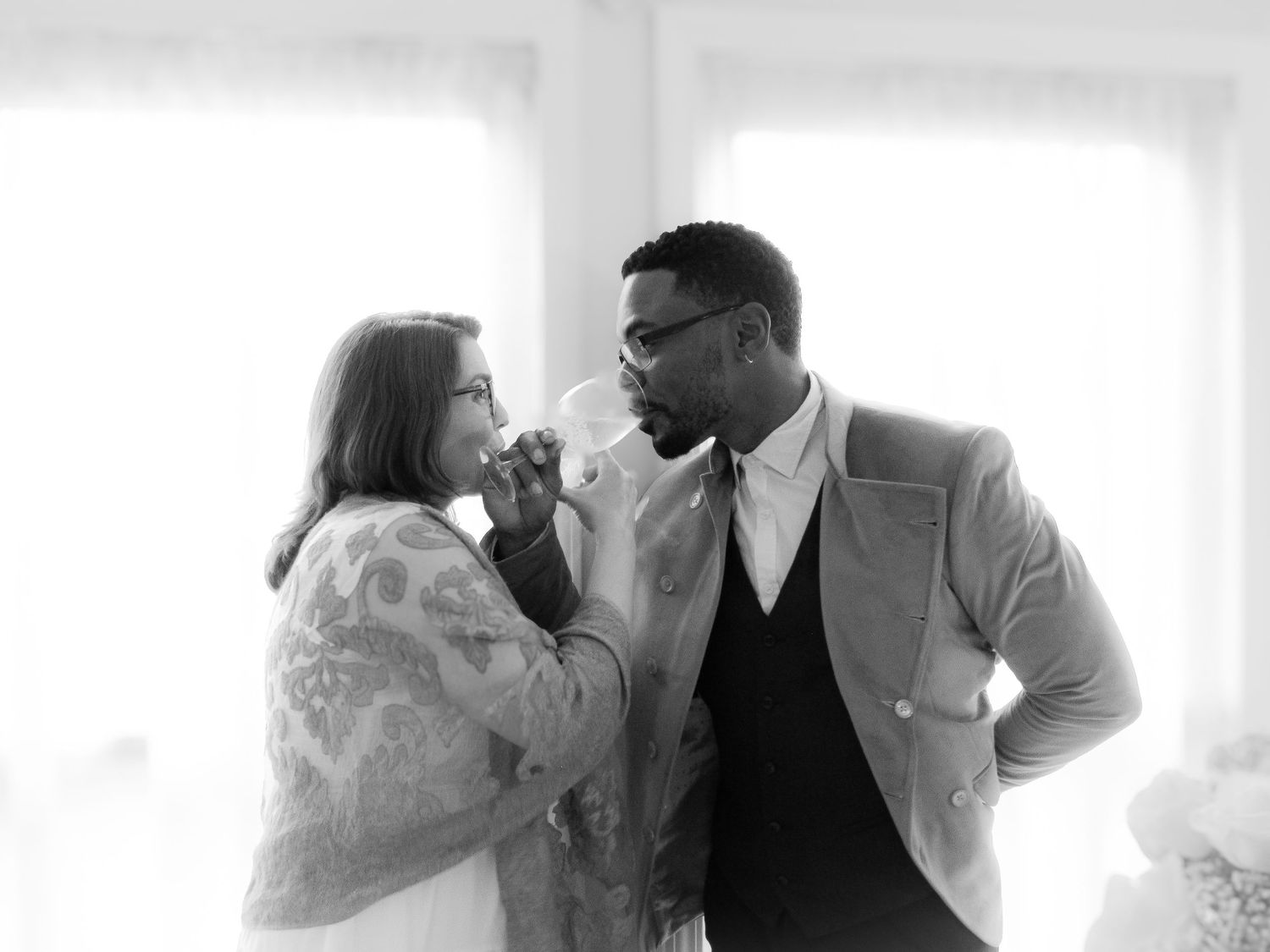 A series of black and white romantic wedding photos showing intimate moments between newlyweds.