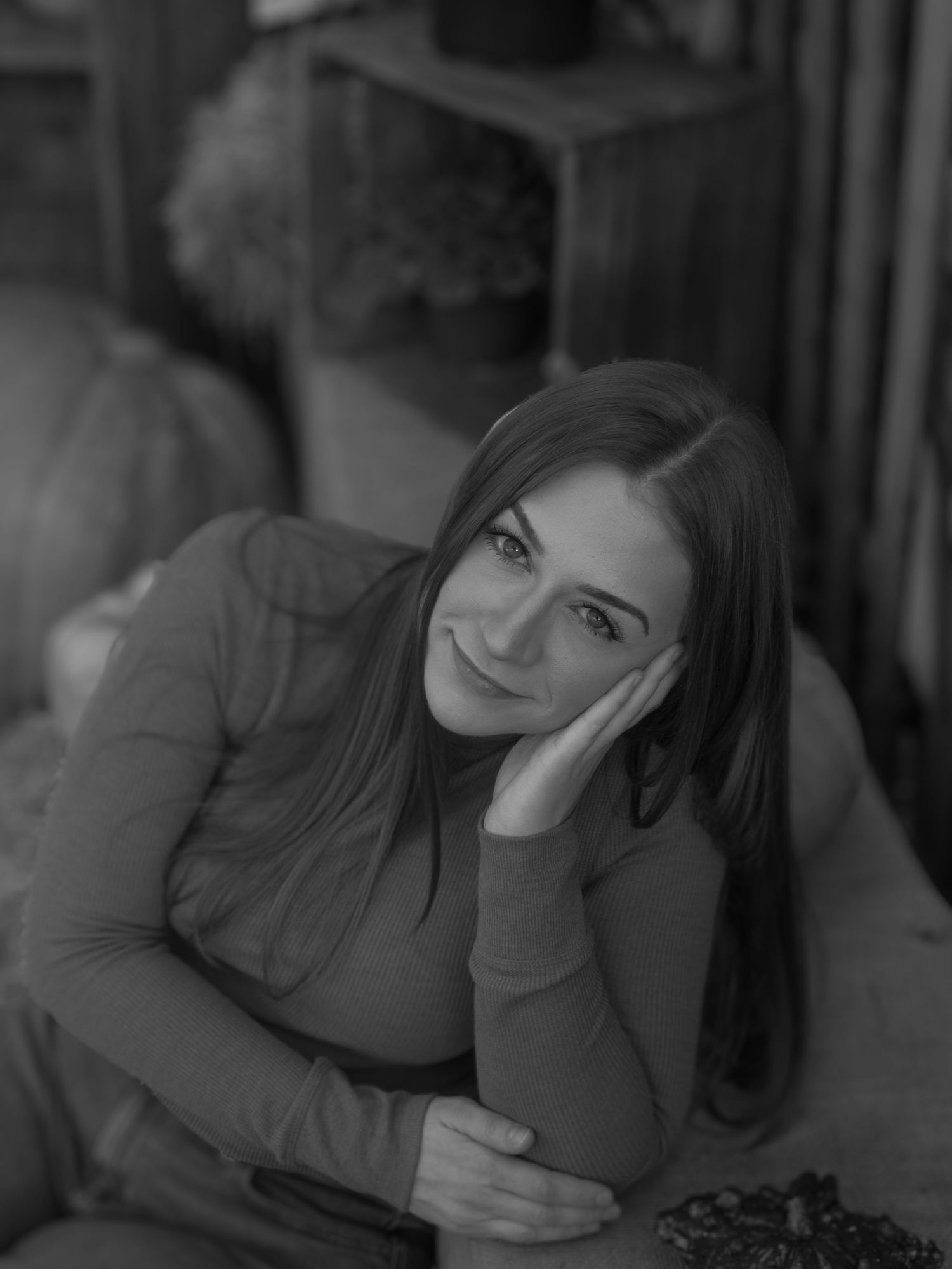Moody black and white portrait in dim lighting.
