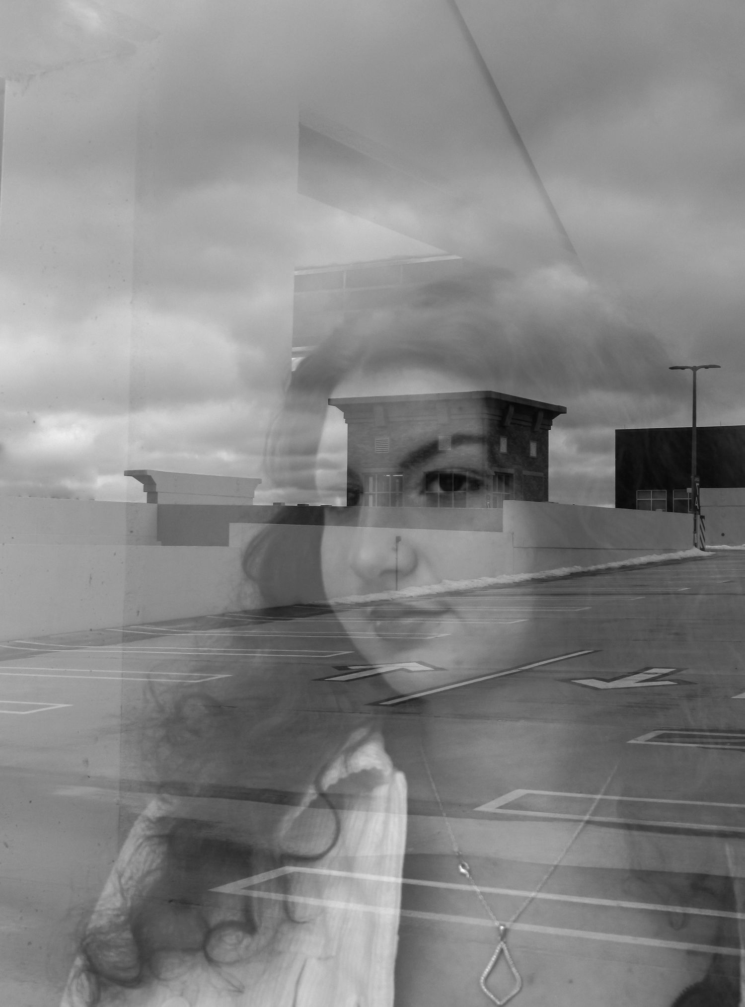 Abstract black and white images showing blurred motion across an empty parking lot.