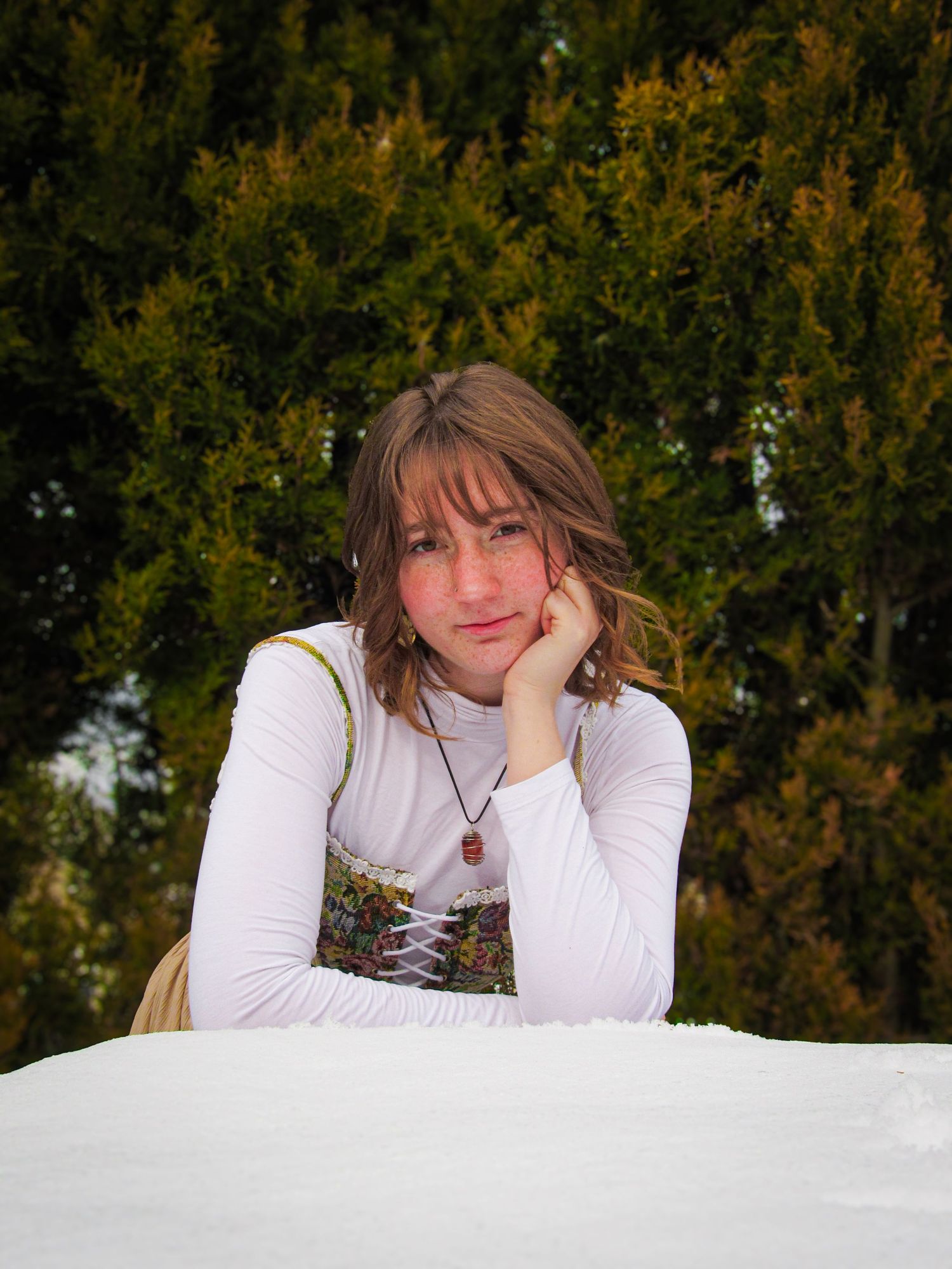 Winter portrait series showing poses against snowy background.