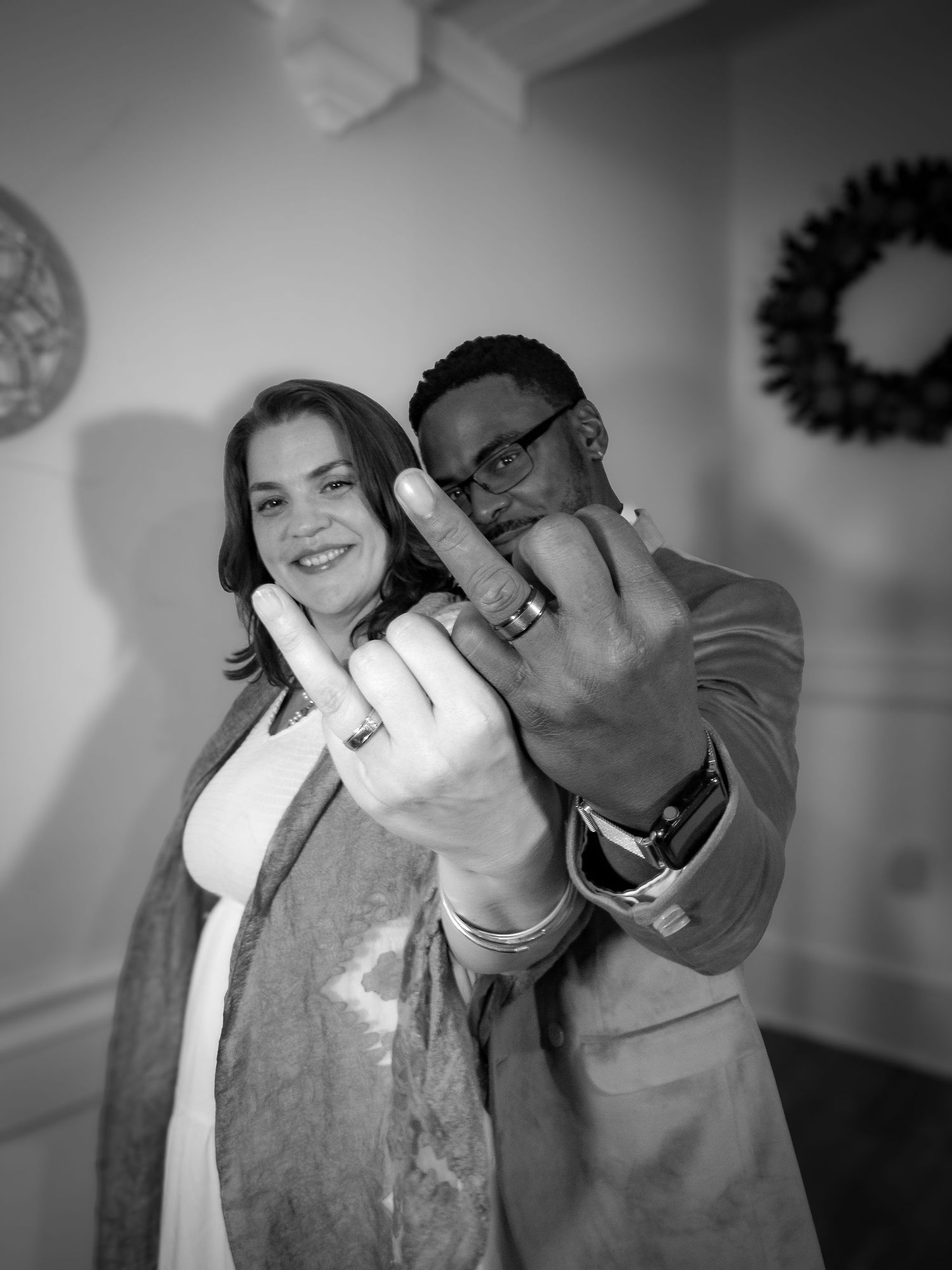 Black and white photo series showing a couple in a playful and affectionate moment together.