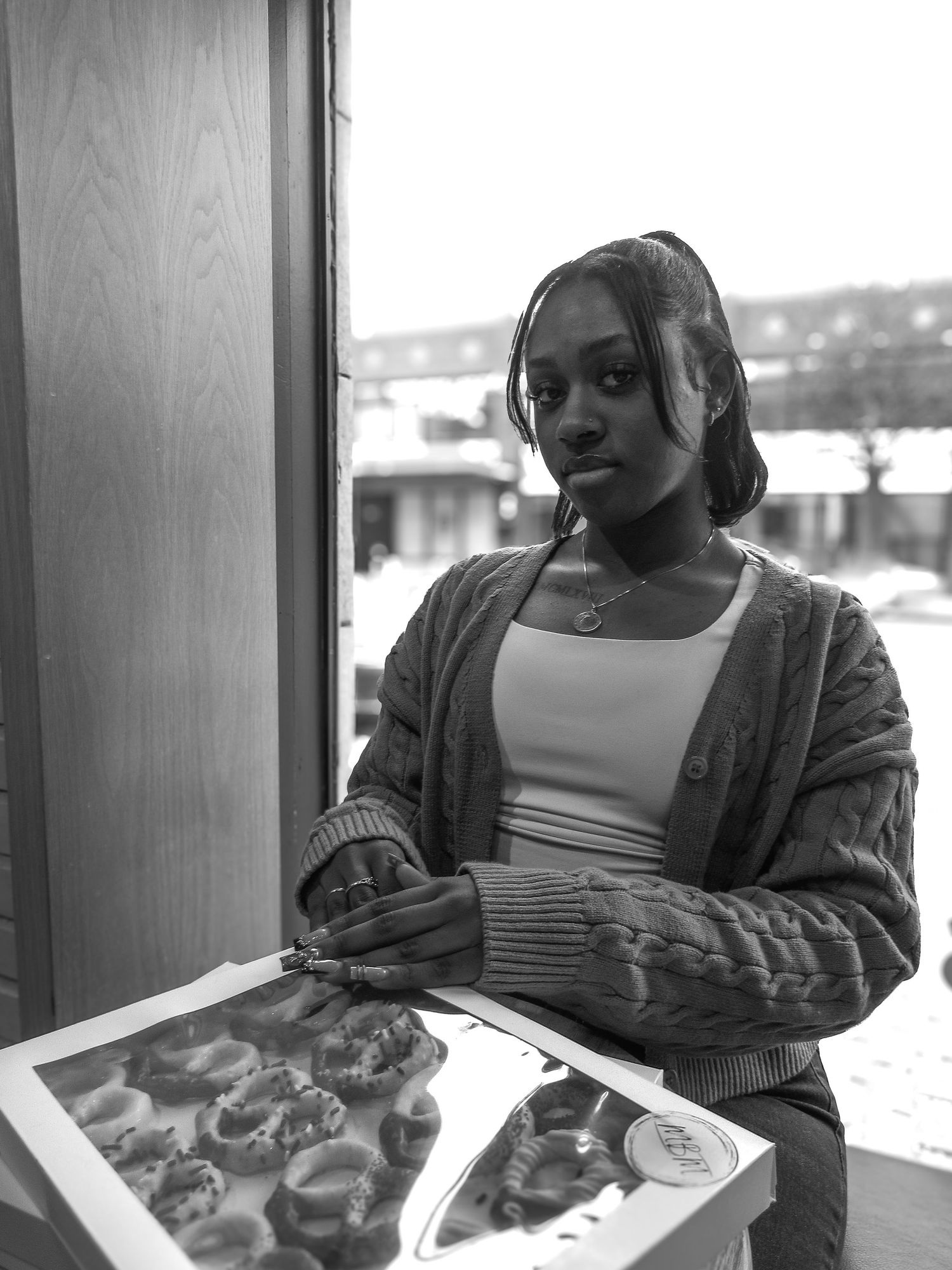 Black and white photo series showing someone seated by a window.