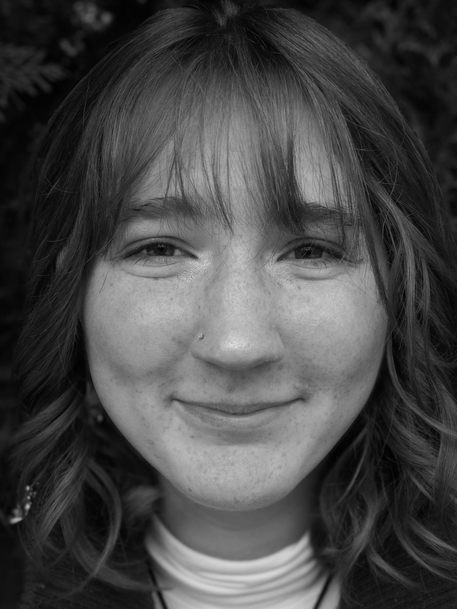 Black and white close-up sequence showing different expressions and smiles.