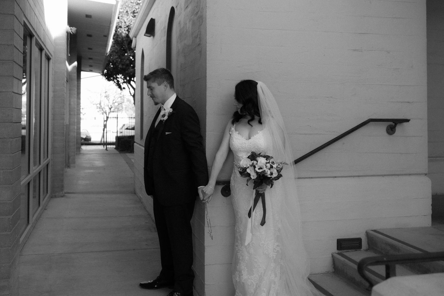 A black and white wedding photo collage showing intimate moments between the couple in various church hallways and settings.