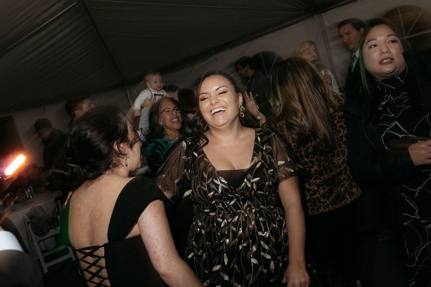 Wedding reception dance floor filled with guests enjoying the celebration.