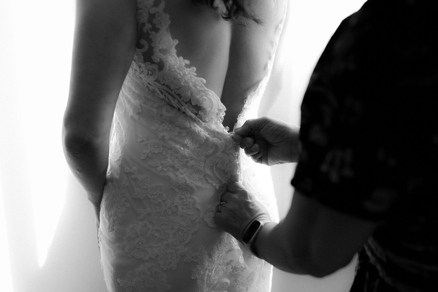 A series of black and white wedding photos showing intimate moments between a bride and groom.