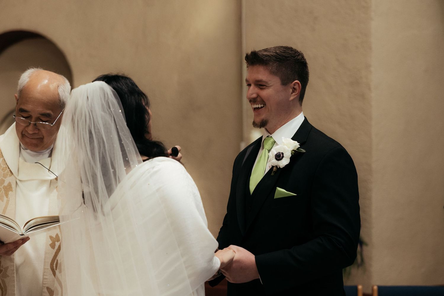 A wedding ceremony unfolds at the altar with religious artwork in the background.