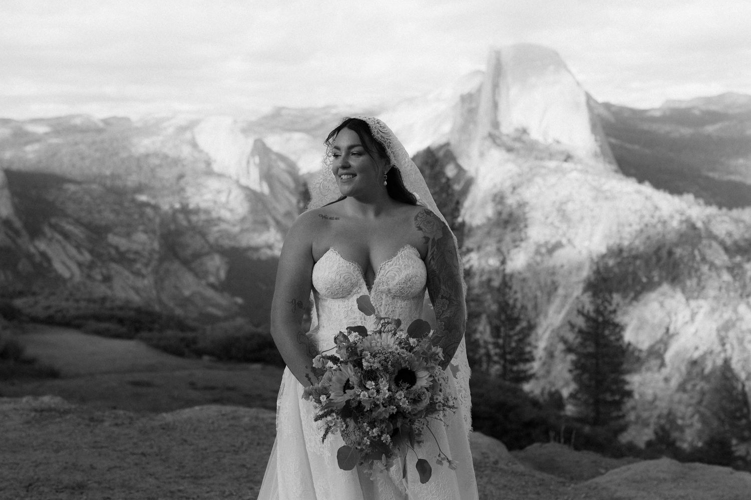 Black and white bridal portrait with Half Dome mountain backdrop at Yosemite.
