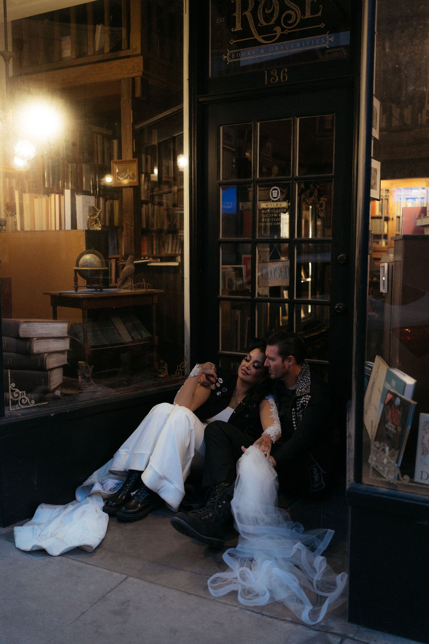 A series of nighttime photos showing figures in white dress near illuminated storefronts on a city street.