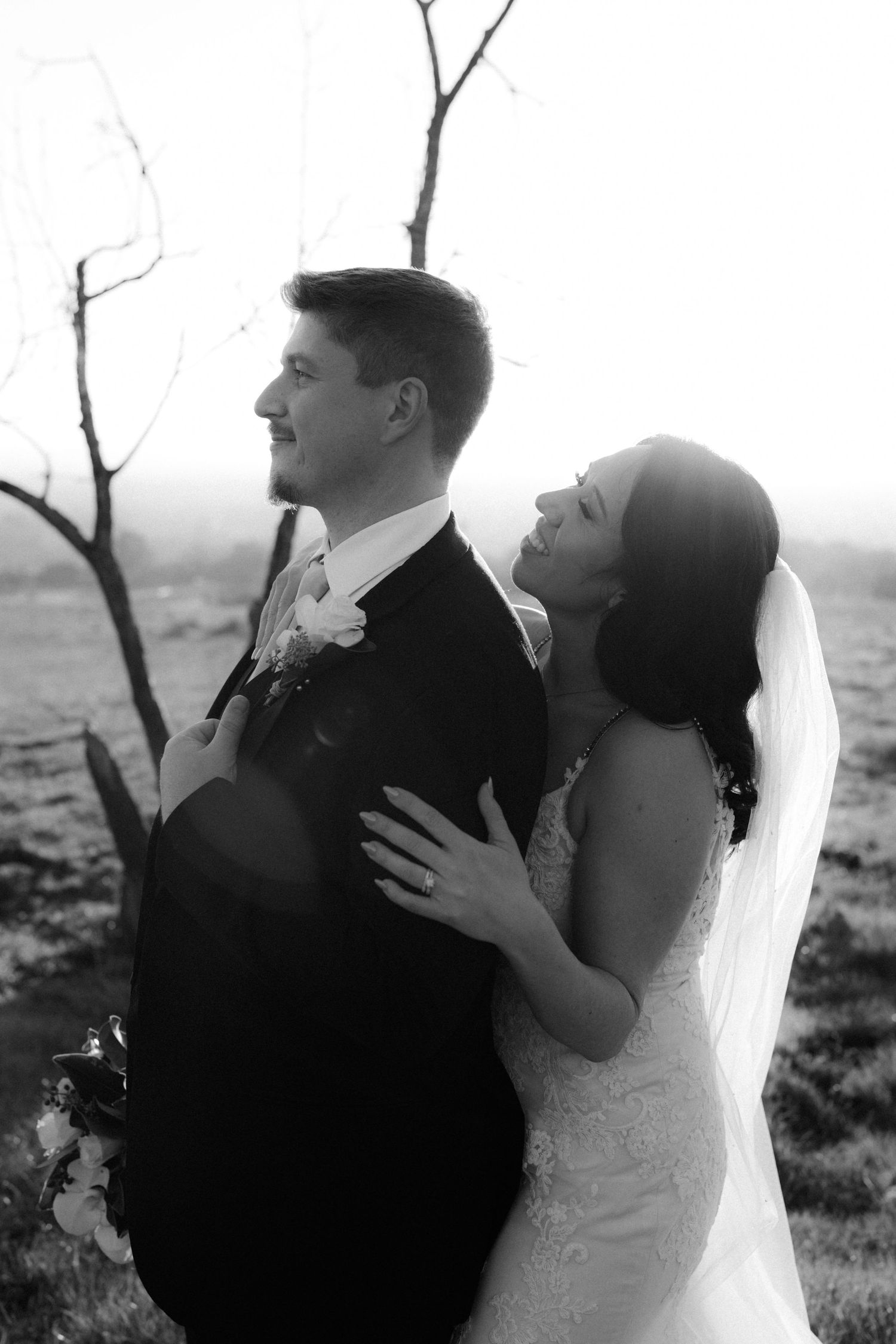 Wedding couple embraces in a series of intimate black and white portraits against a natural backdrop.