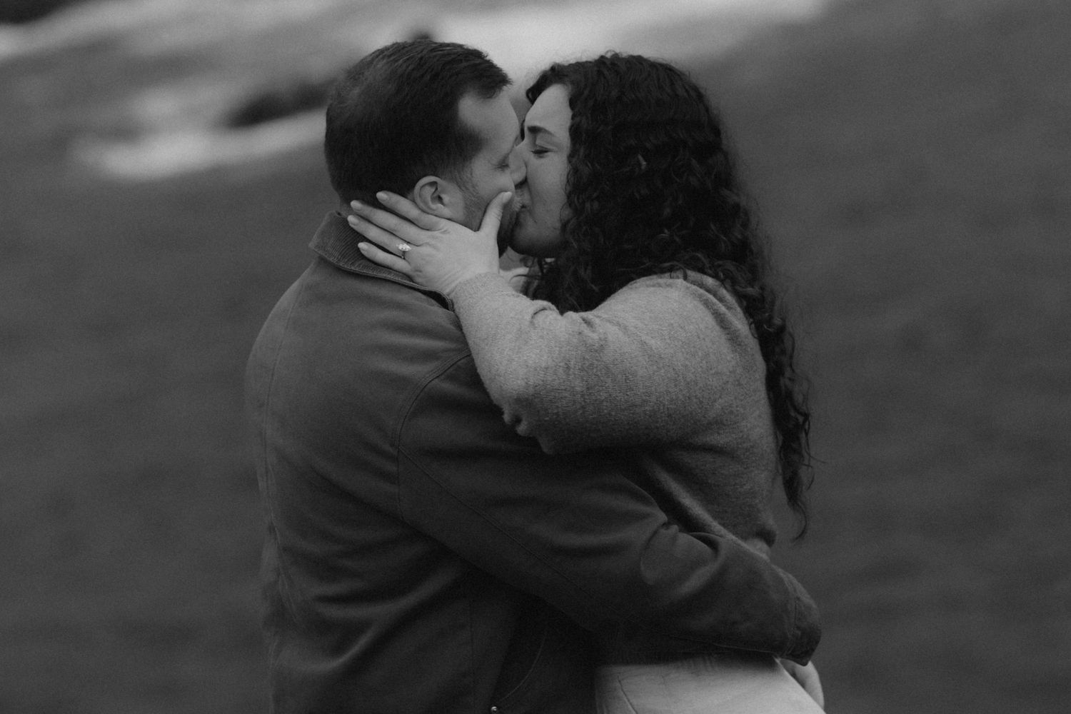 A romantic black and white photo sequence showing a couple embracing and kissing in an intimate moment.