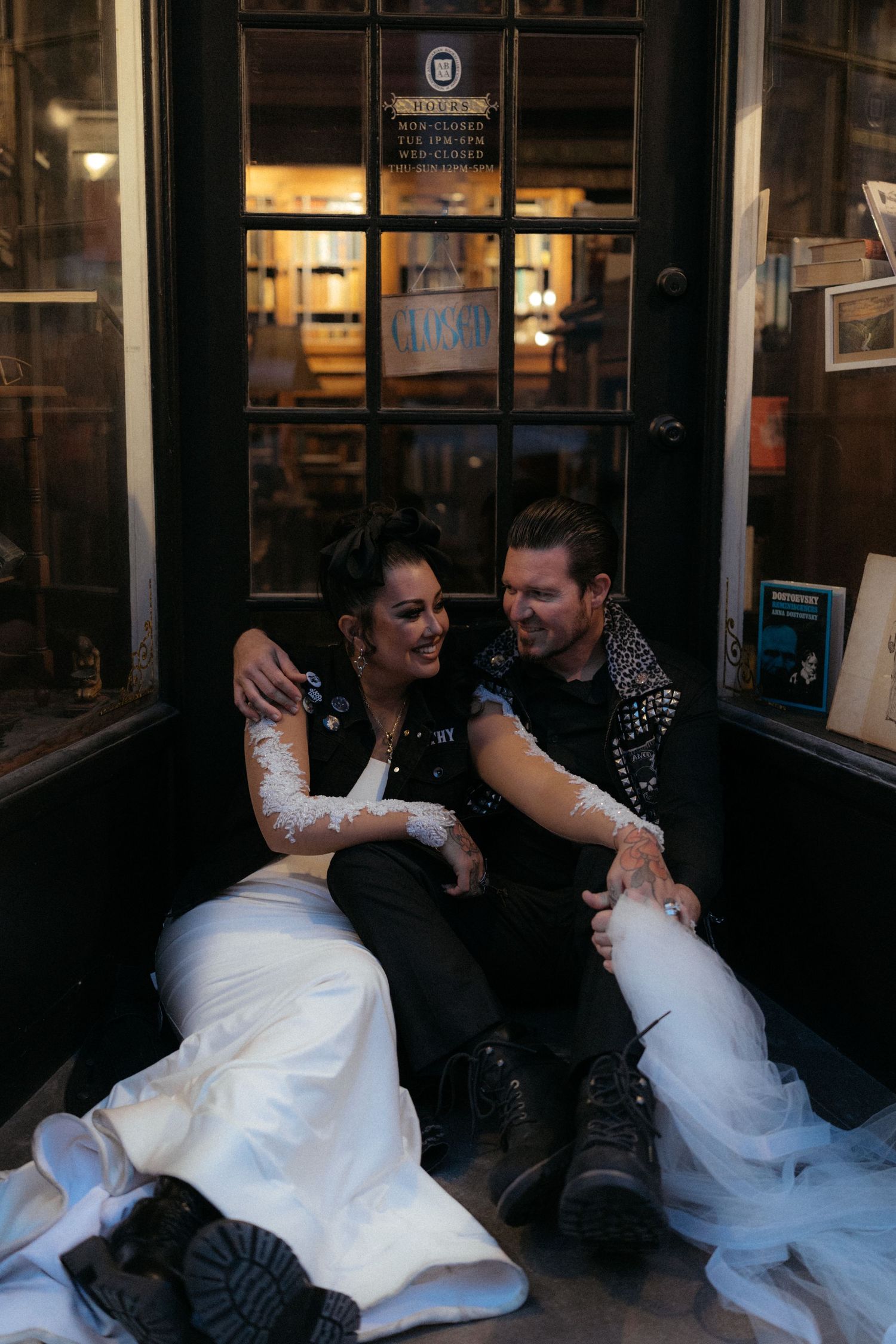 Sequence showing a couple sitting and posing together outside a shop window.