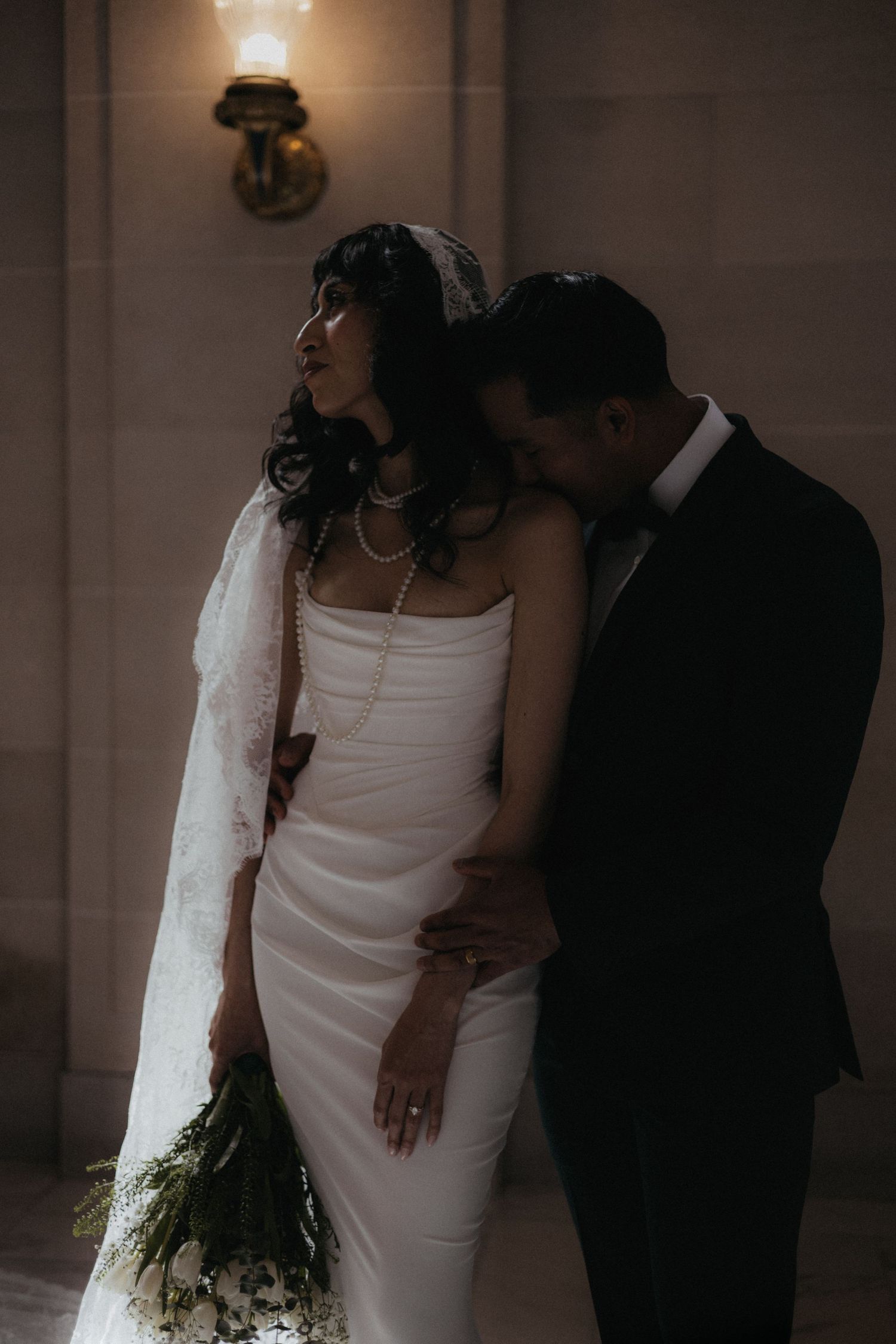 Atmospheric wedding photos showing the couple in dramatic lighting and shadows.