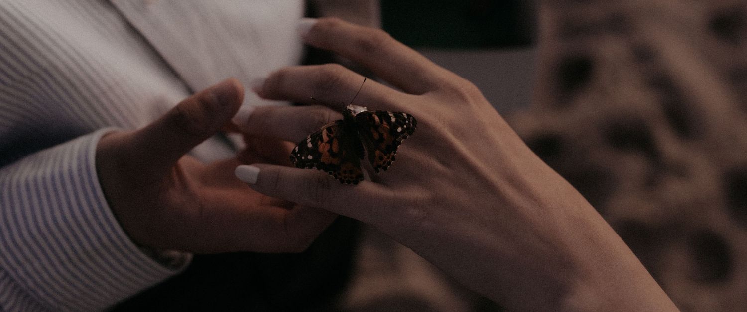 Close-up detail of hands exchanging rings during an intimate ceremony.