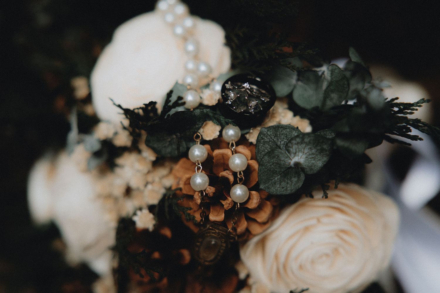 Artistic macro shot of wedding floral arrangements with soft pink and cream tones.