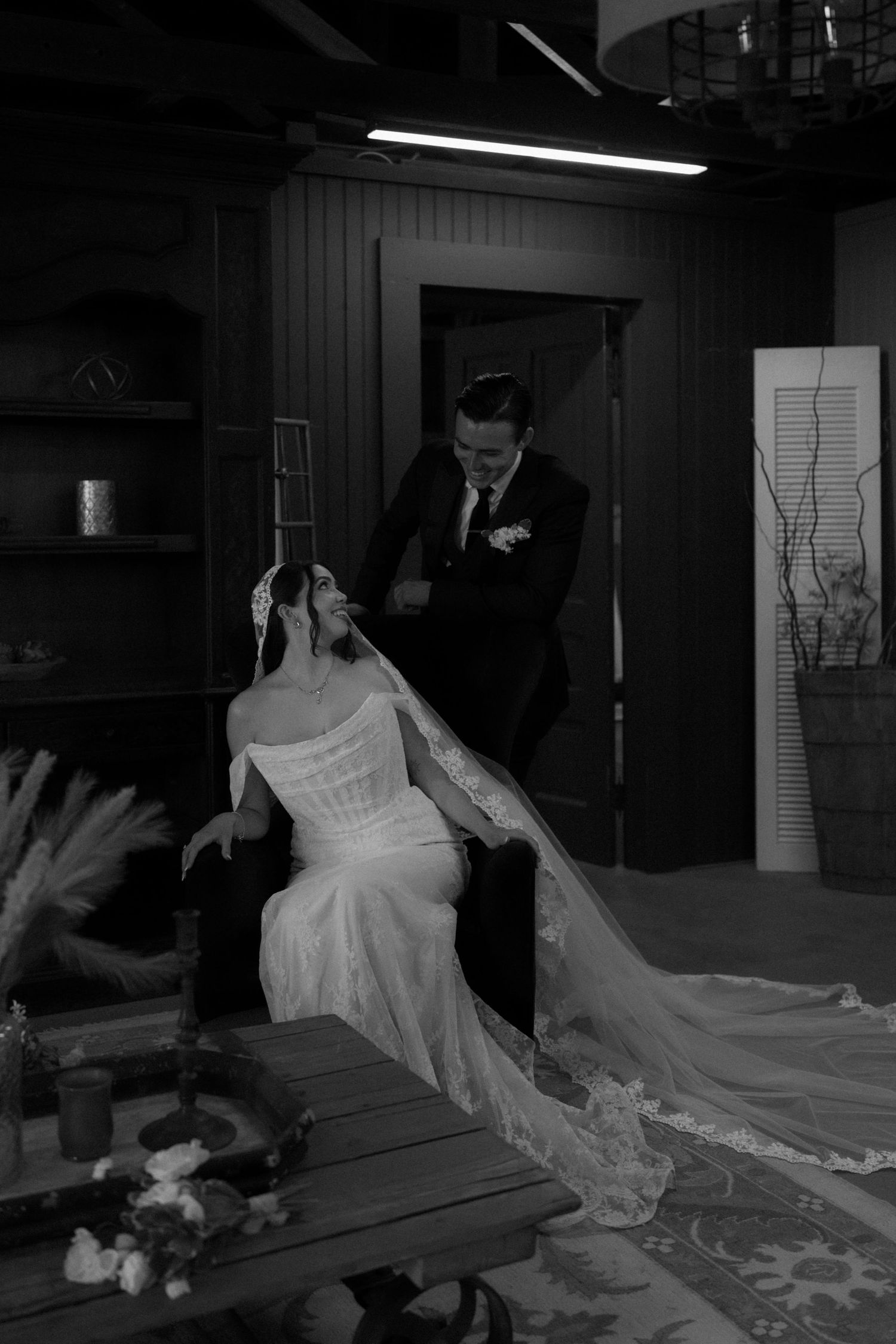 A sequence of black and white photos showing a couple dancing and twirling in formal attire.