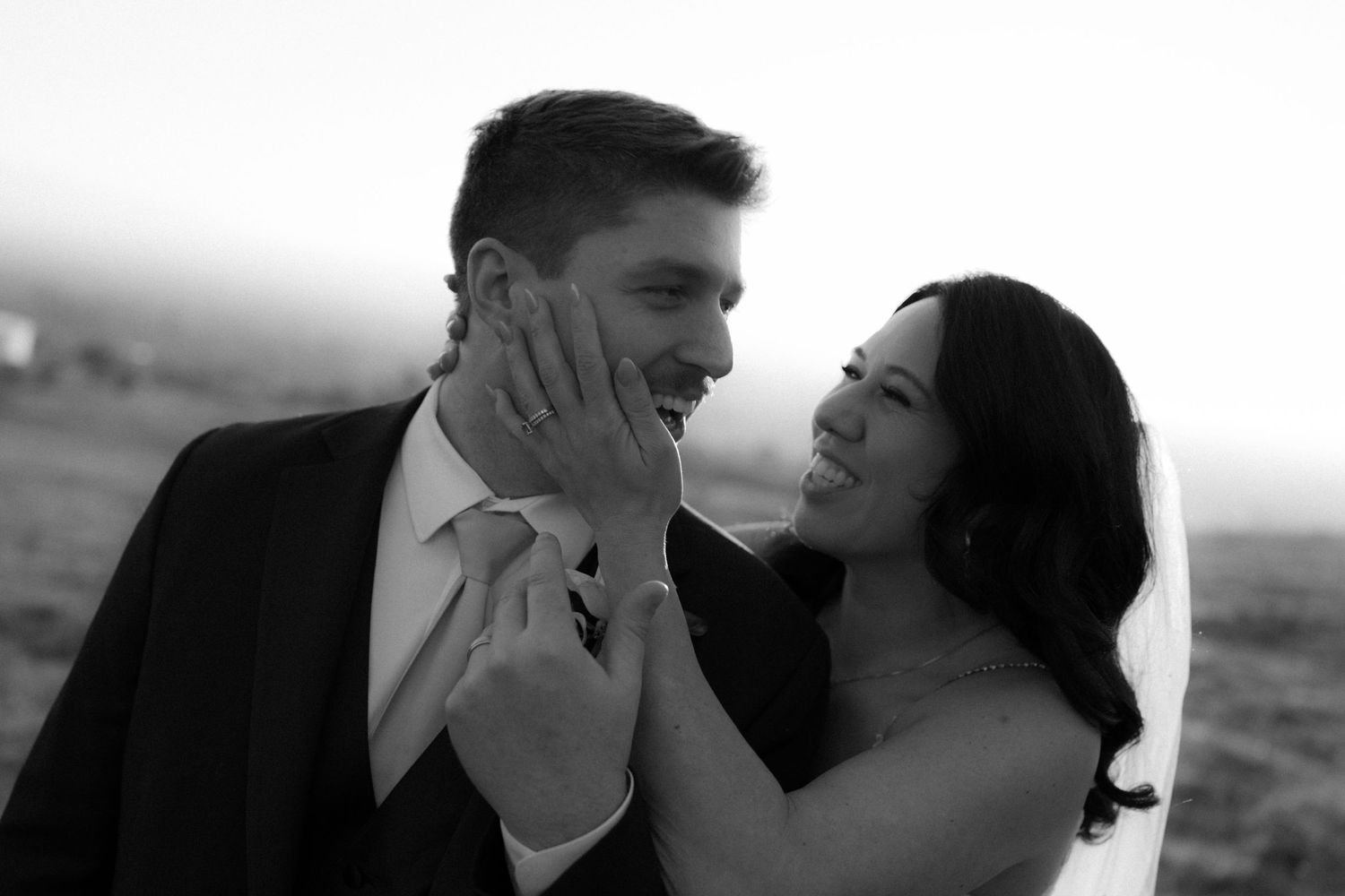 A romantic black and white photo series showing intimate moments between a couple in an outdoor setting.