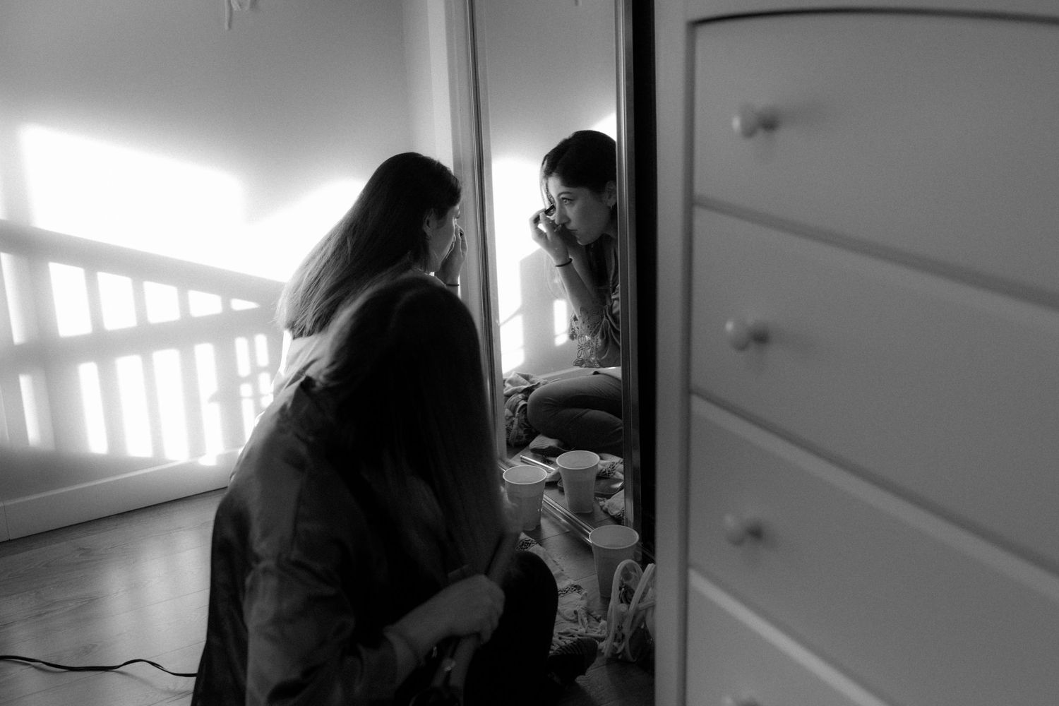 A series of black and white photographs showing intimate moments in a home interior.