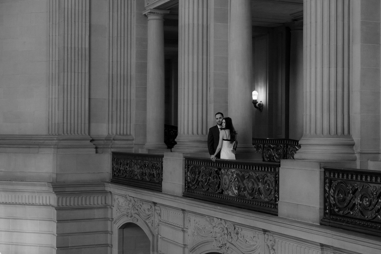 Elegant stone columns and pillars line the exterior of a grand historic building with ornate architectural details.
