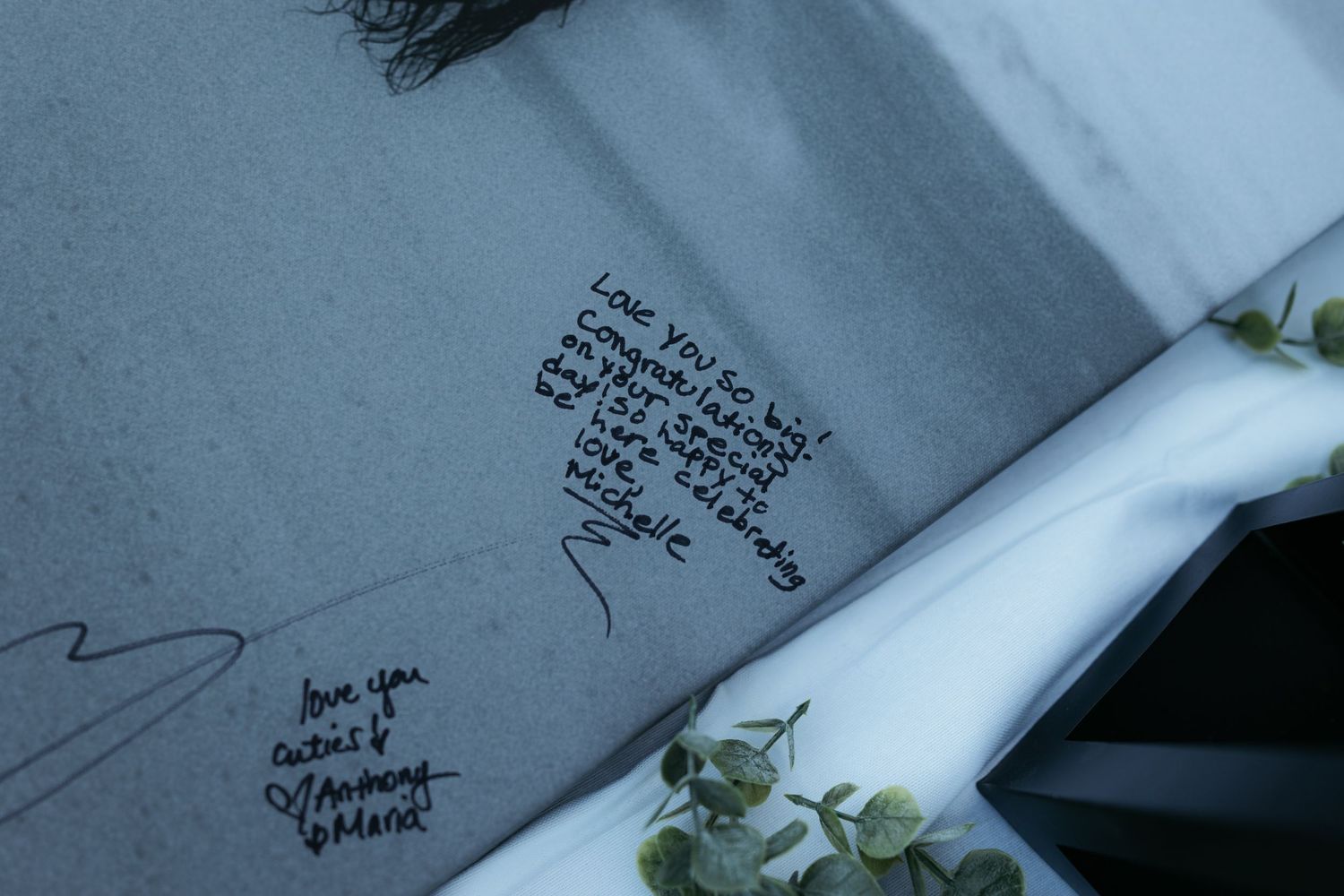 Close-up view of handwritten messages on what appears to be a guest book or card.