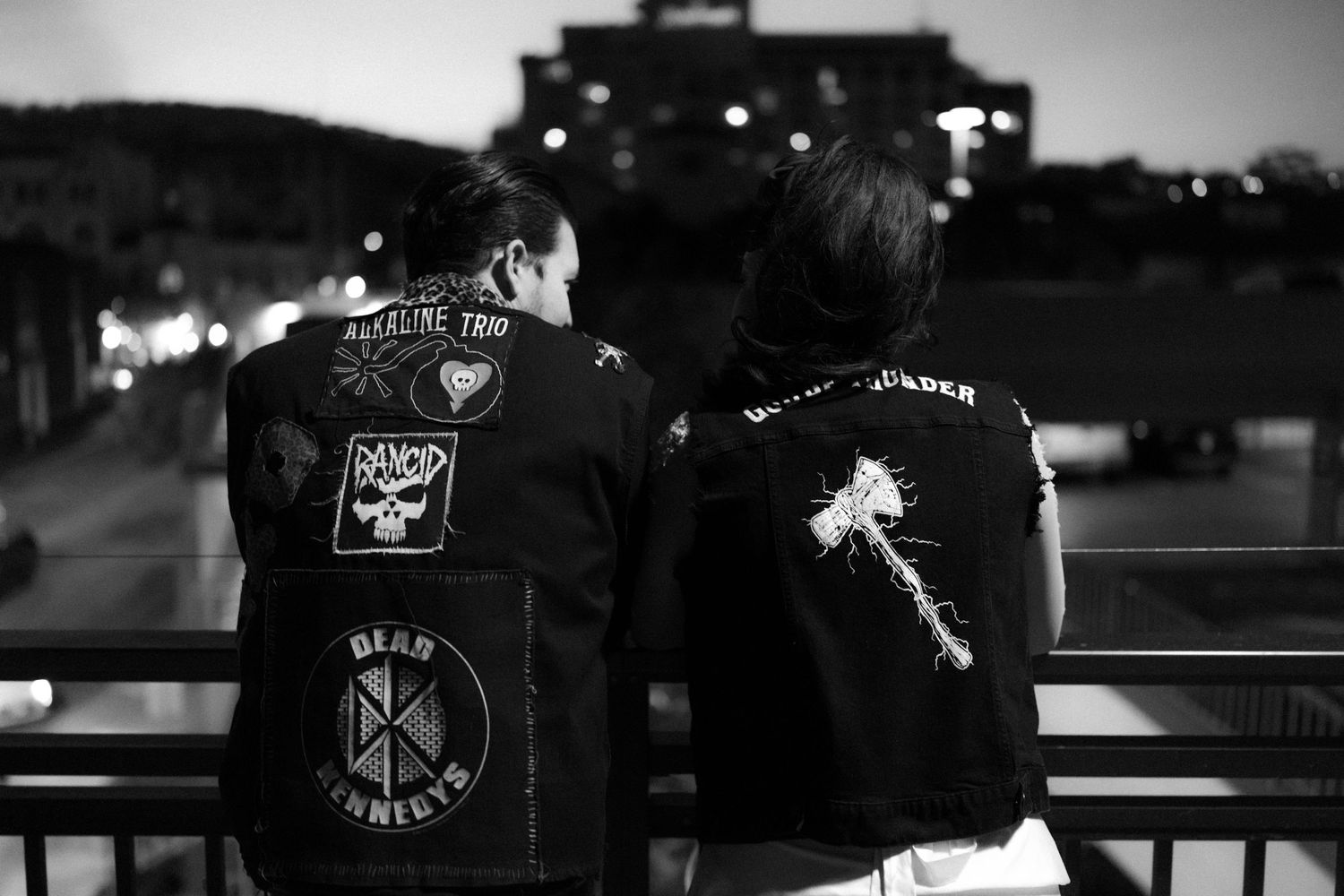 Black and white sequence showing couple in leather jackets against urban backdrop.