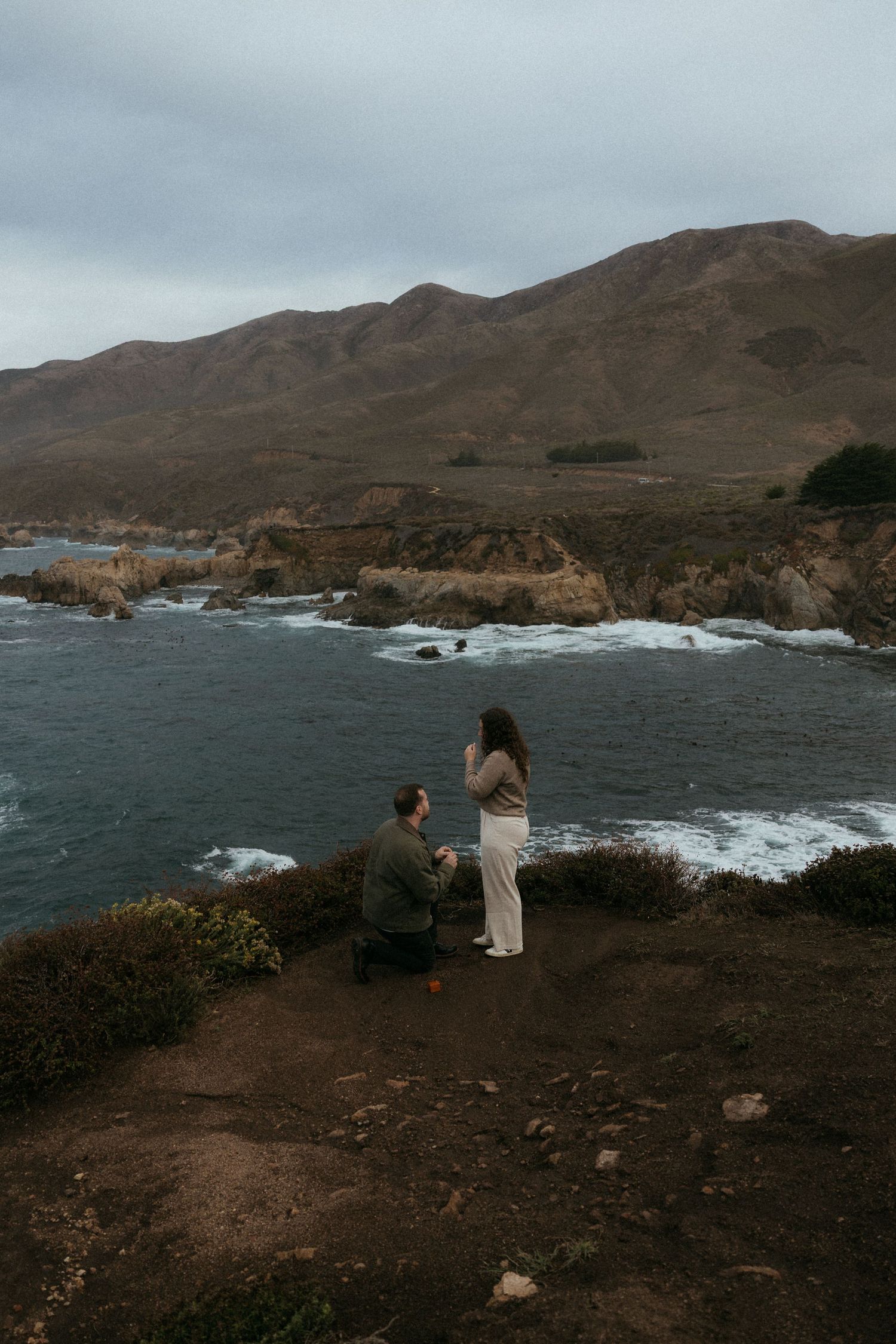 Dramatic coastal landscape with rugged cliffs and crashing waves along Big Sur's rocky shoreline.