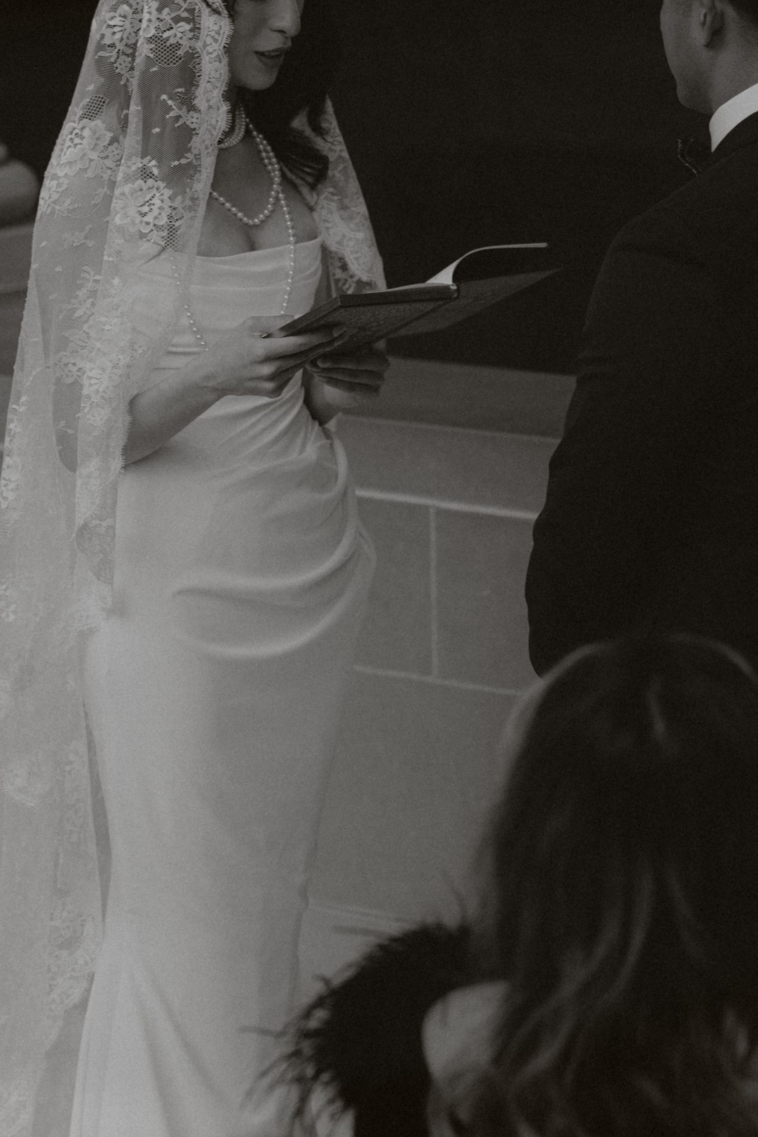 A wedding ceremony moment captured in black and white photography.
