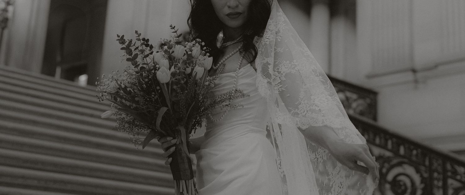 Artistic black and white bridal photography with dramatic lighting and shadows.