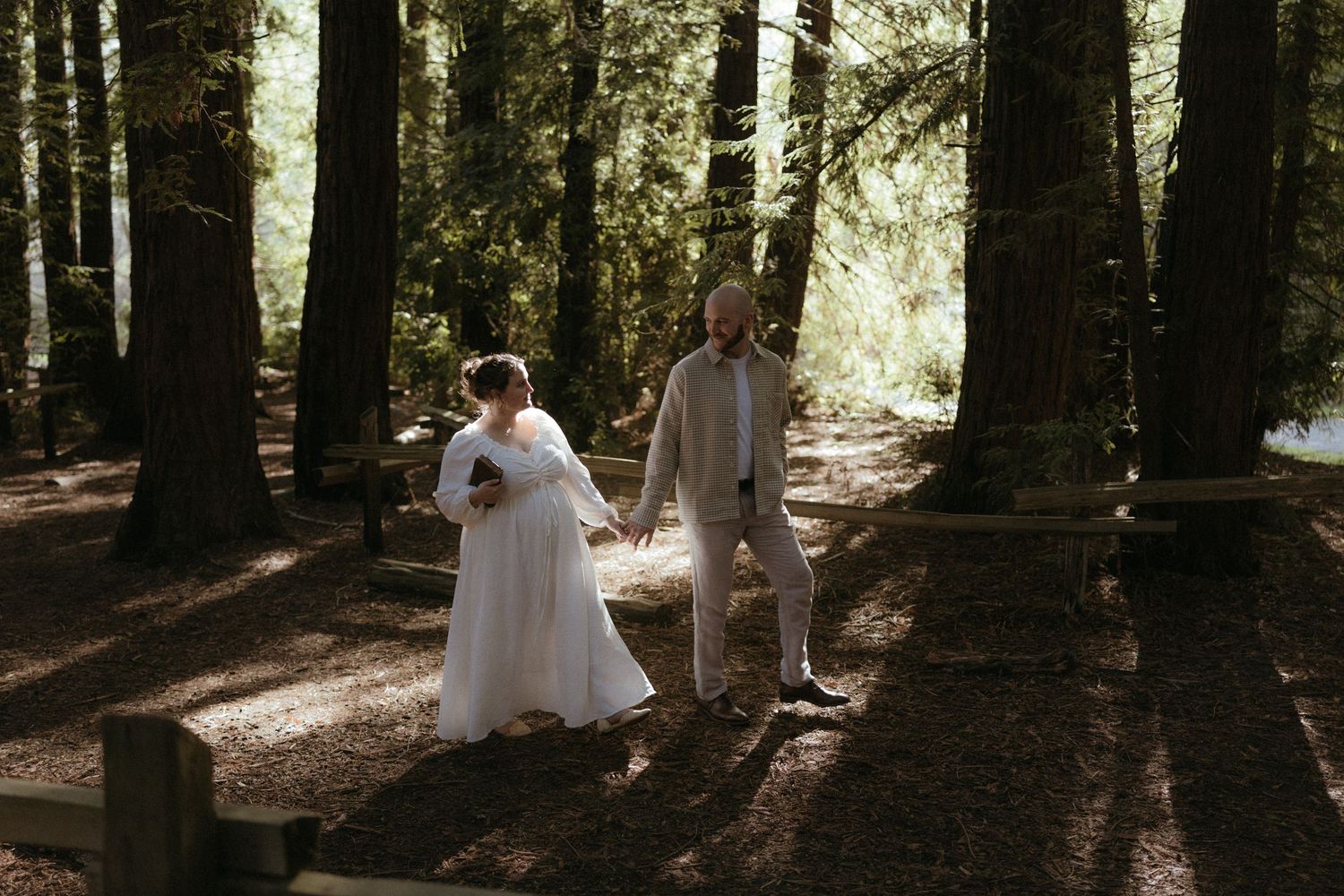 Artistic forest photography series showing intimate moments between two people in white attire.