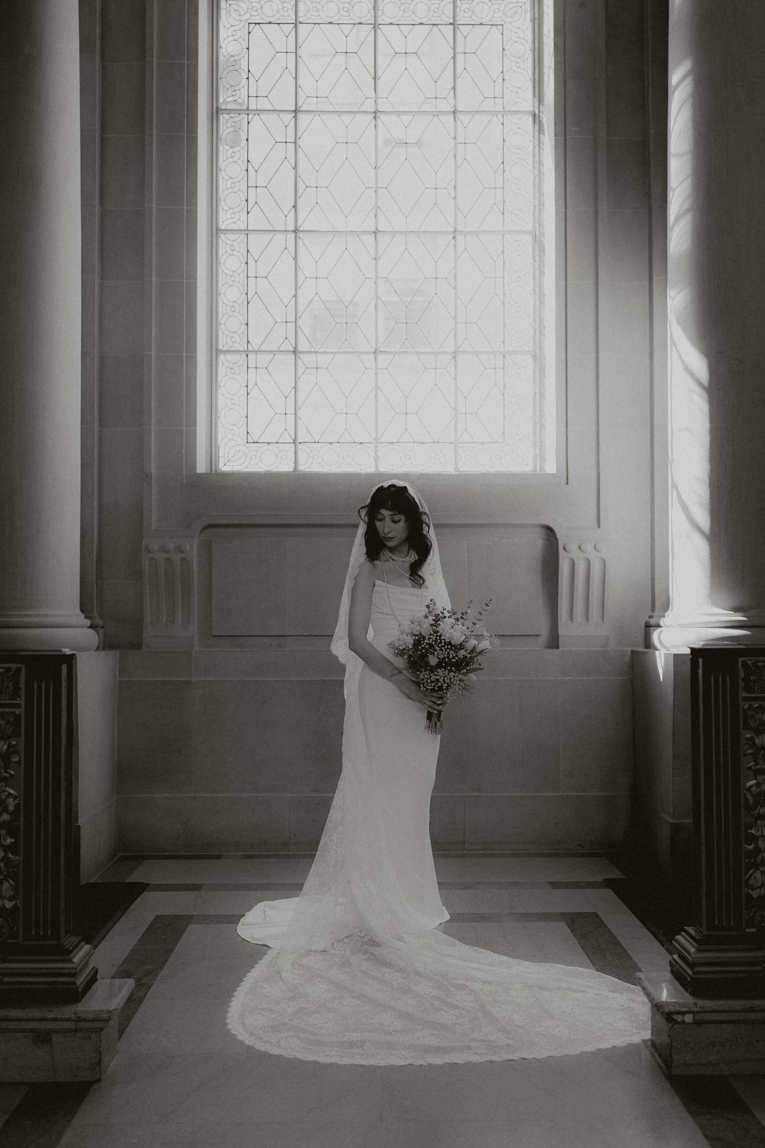 A bride in a flowing white wedding dress poses gracefully in a series of artistic black and white photographs.