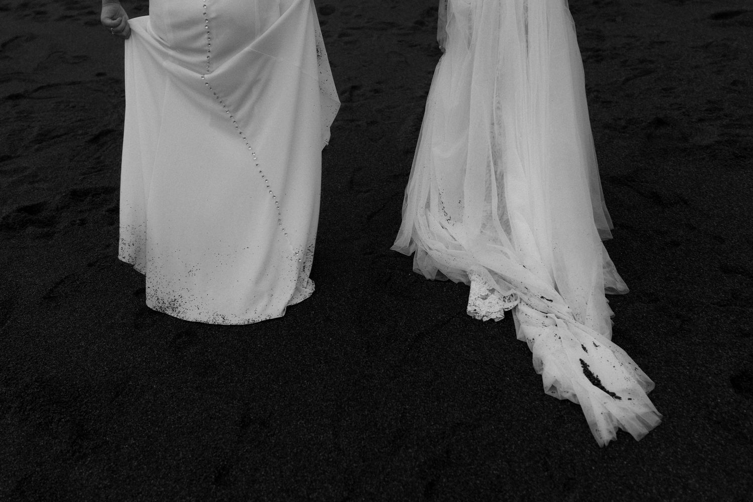 White wedding dresses flow gracefully against a dark background.