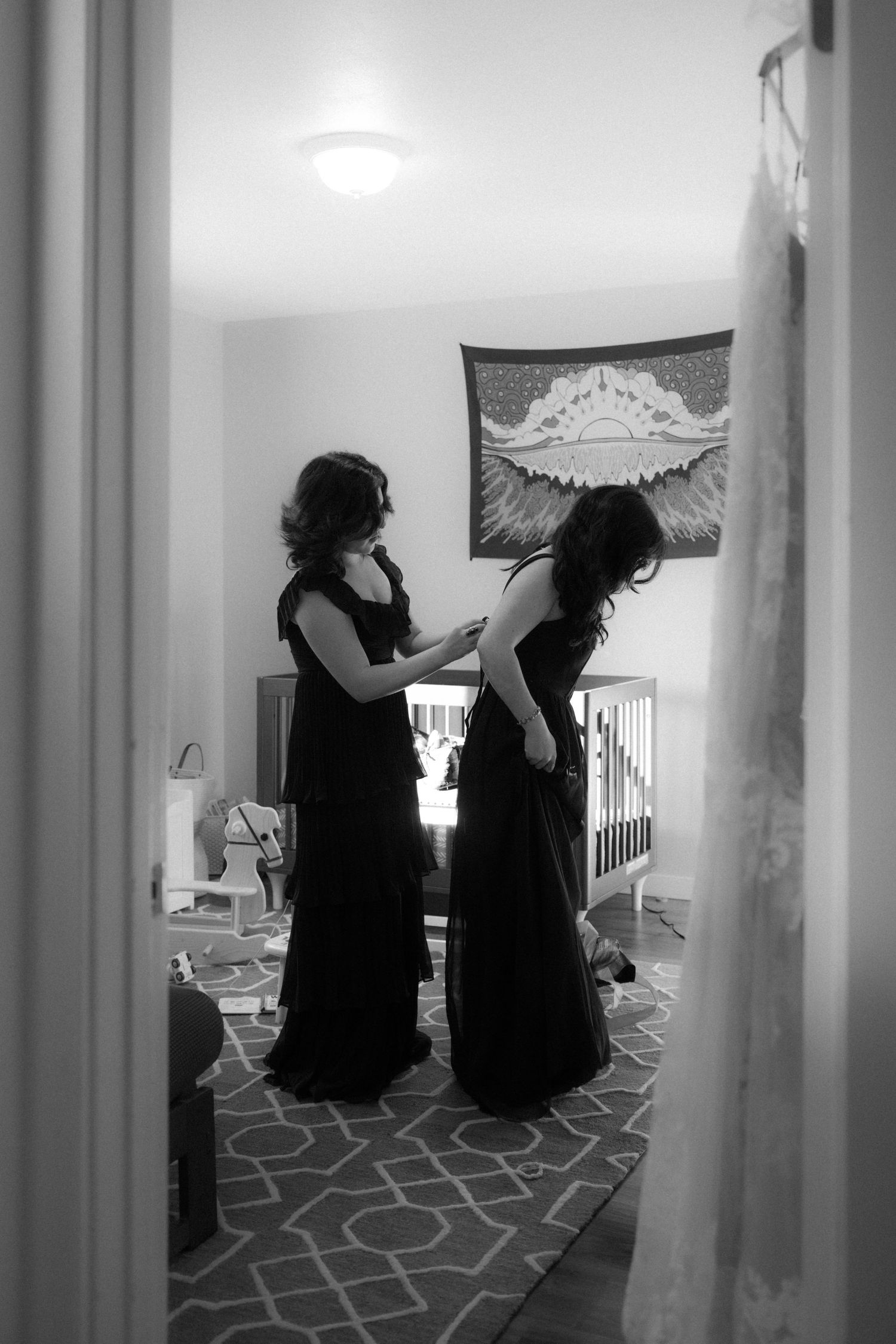 Silhouettes of people sitting in a nursery room with angel wing decorations on the wall.