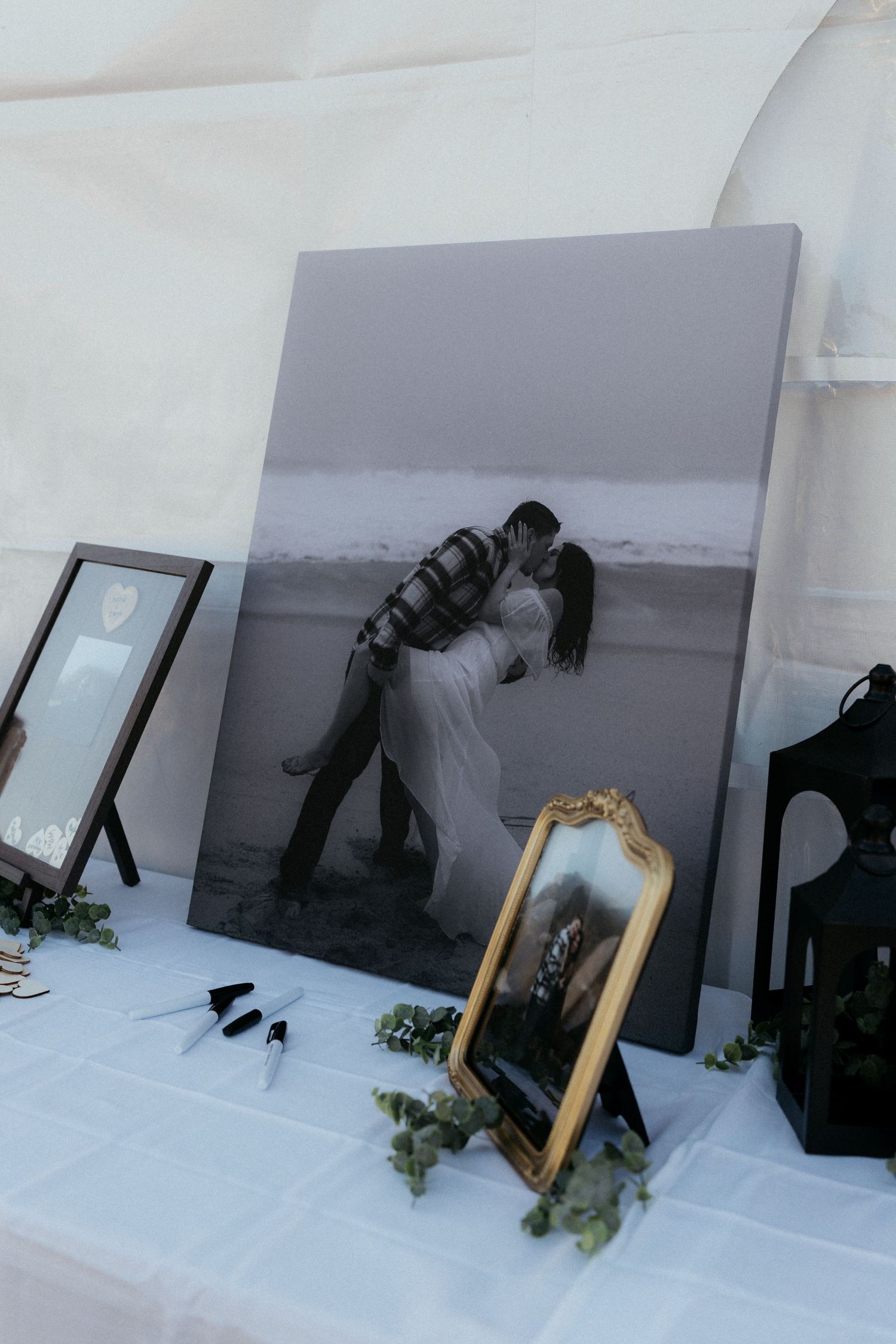 Behind the scenes photo setup with lighting equipment and props against a white backdrop.