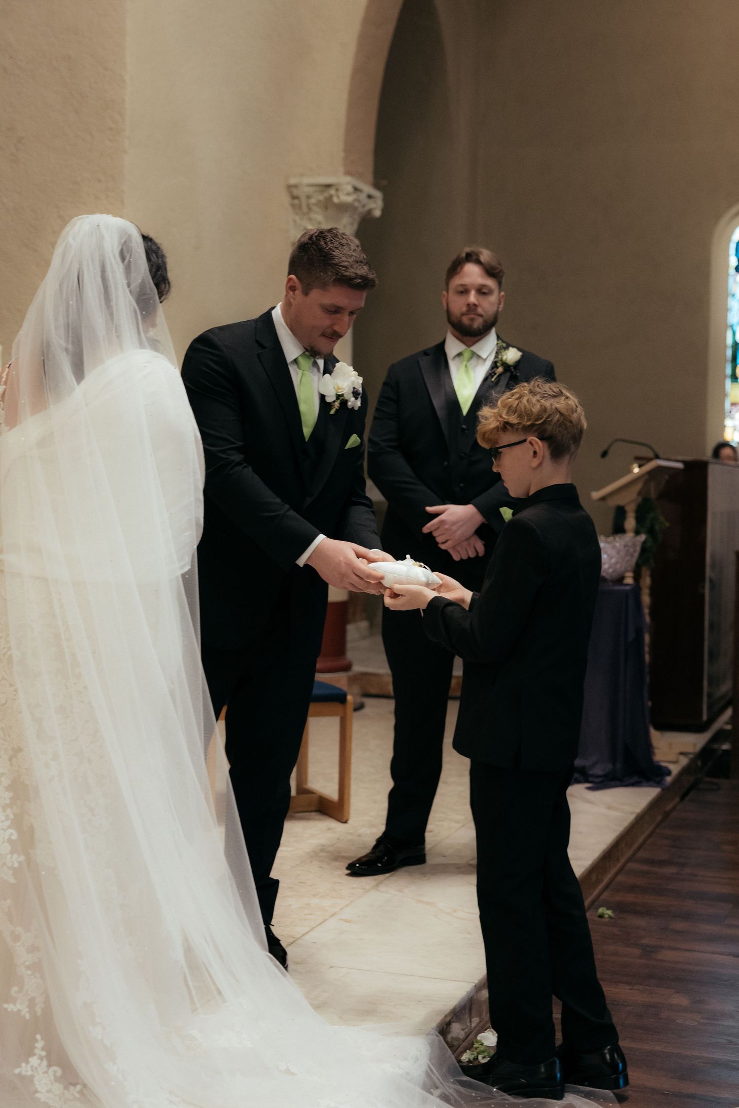 A touching moment during the wedding ceremony as a ring bearer presents the rings.