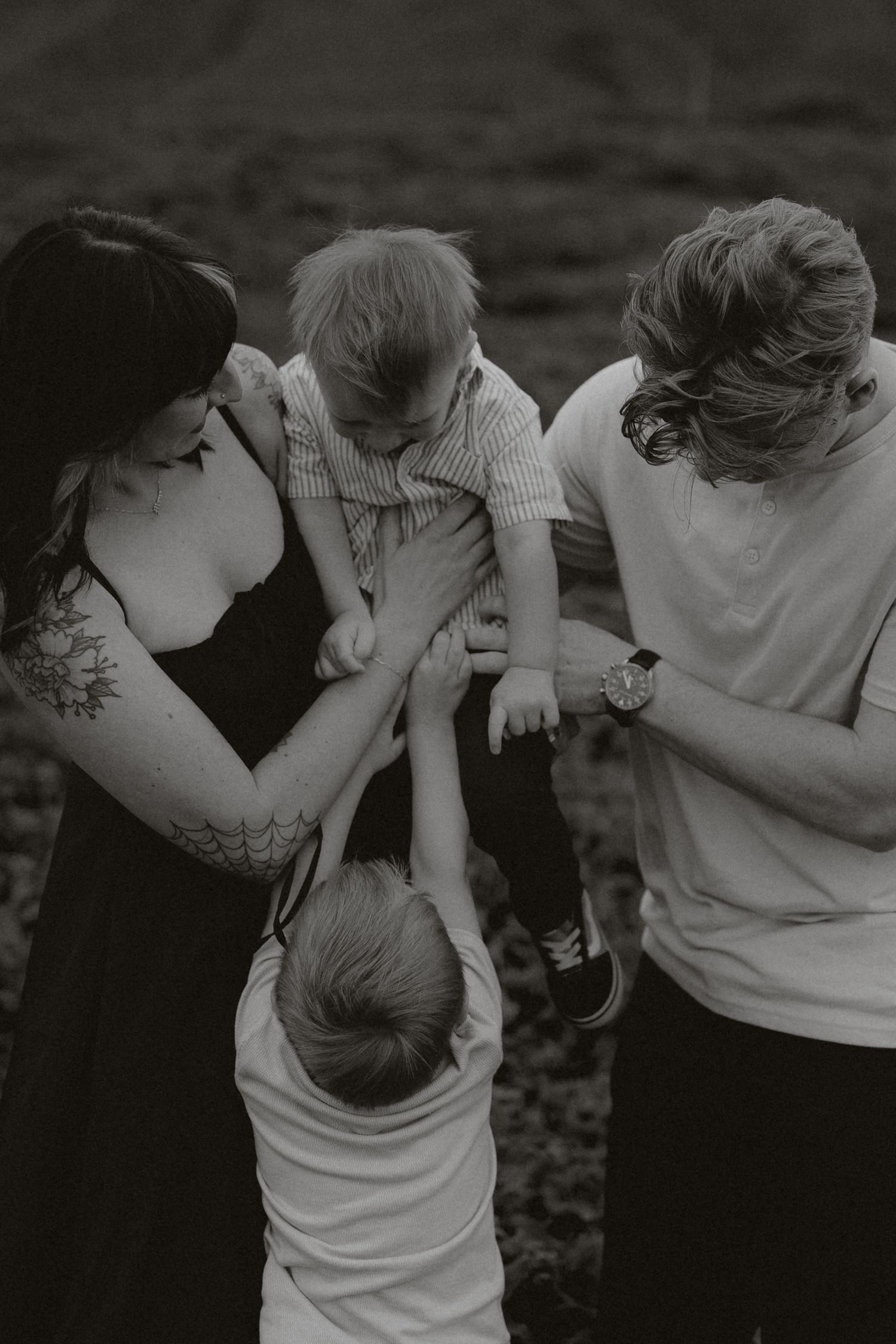 A romantic black and white photo series showing a couple embracing and sharing intimate moments outdoors.