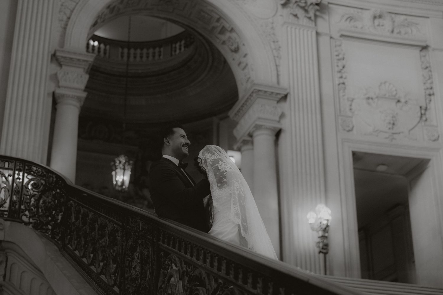Ornate architectural details of a classical building interior with curved staircase.