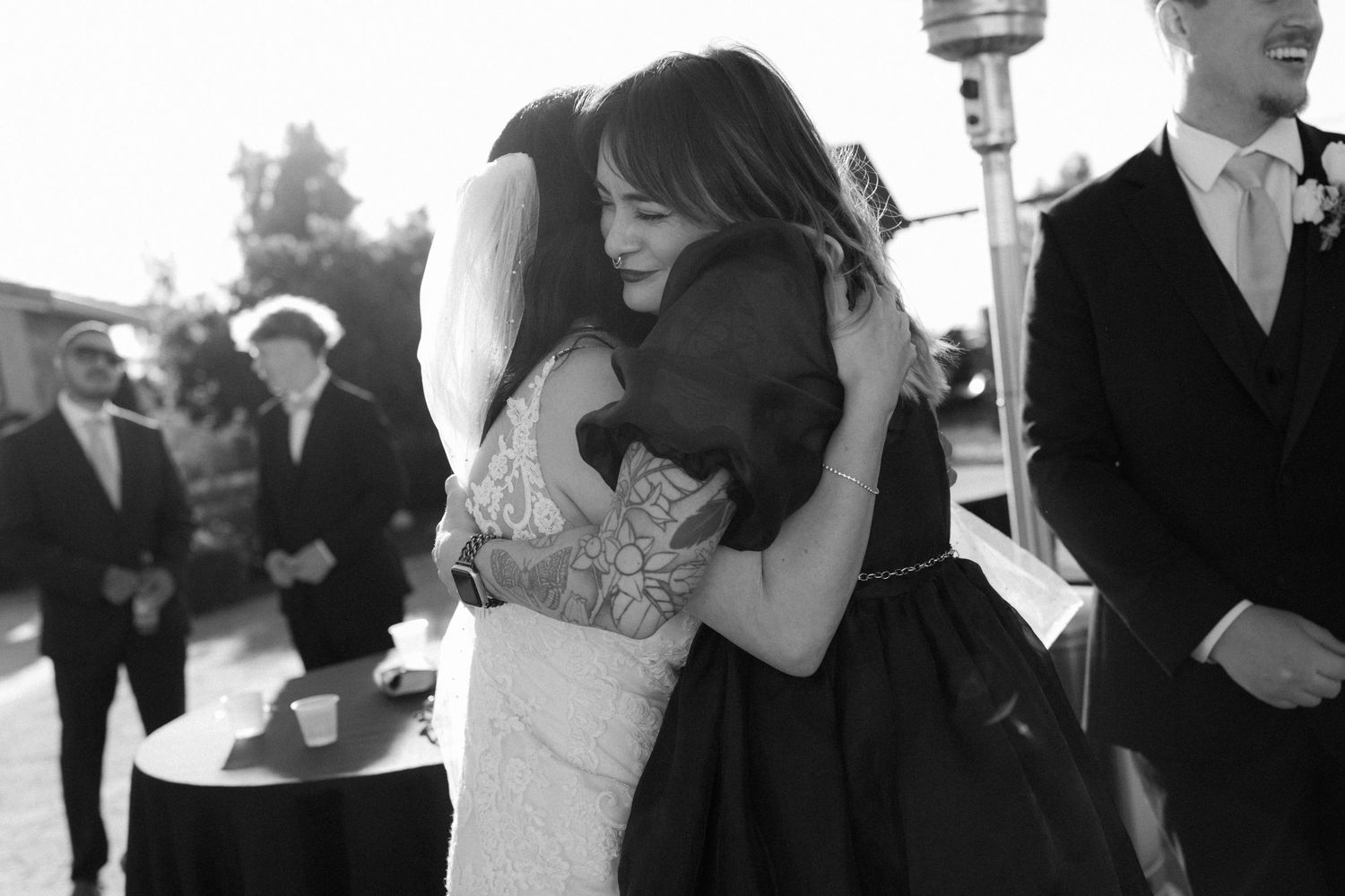 Black and white candid photos of people celebrating at an outdoor event.