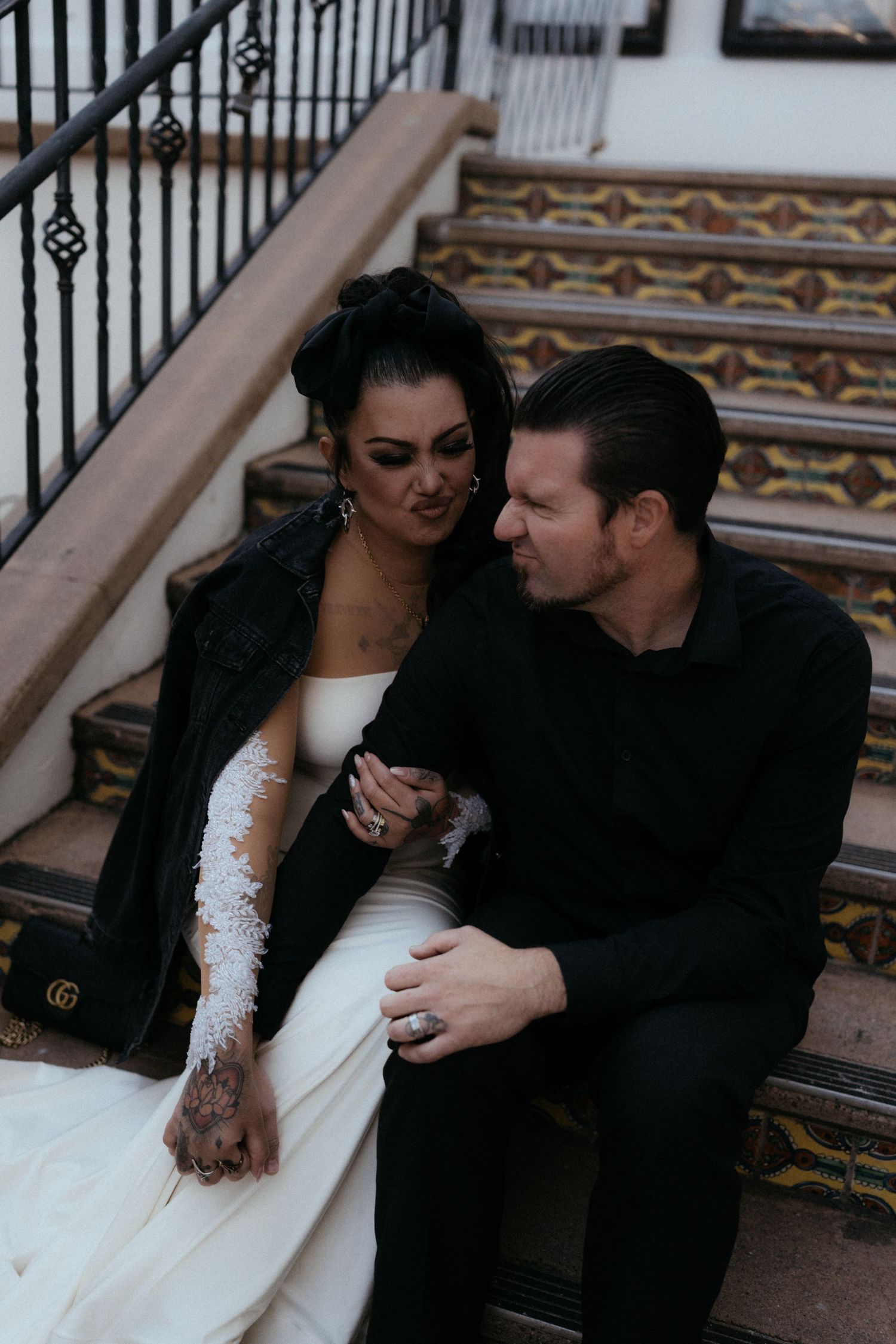 An intimate moment captured on decorated theater steps with ornate tile work.