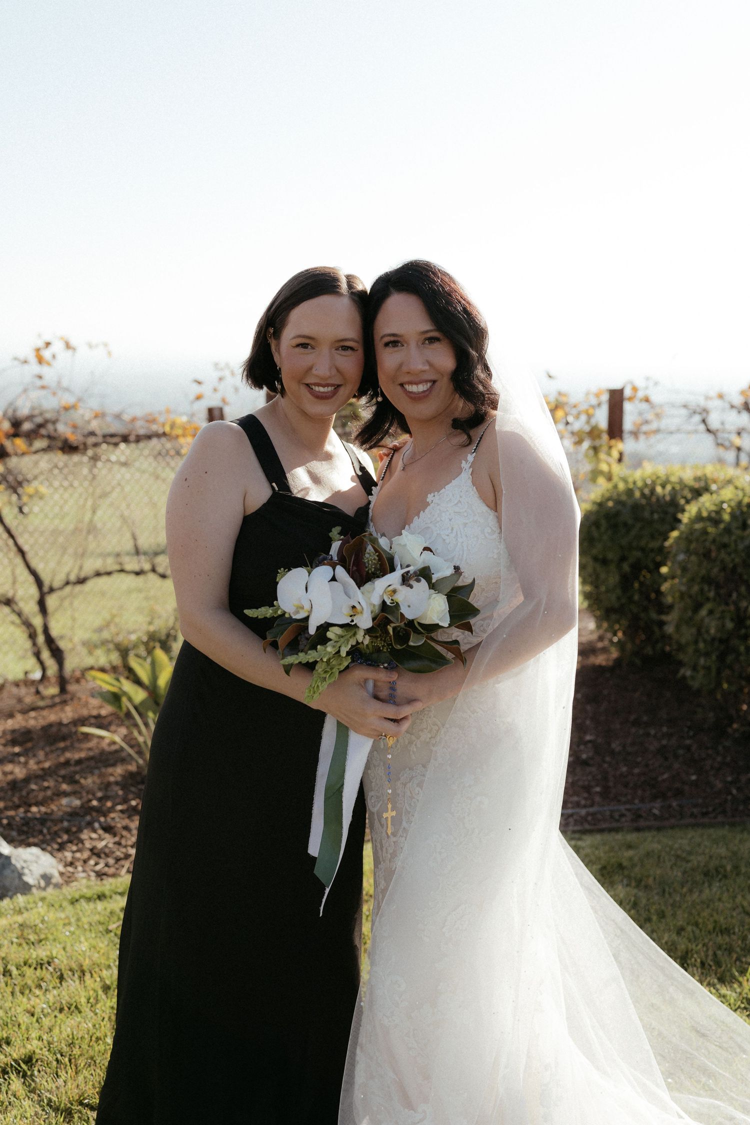A happy couple shares joyful moments together on their wedding day in an outdoor garden setting.