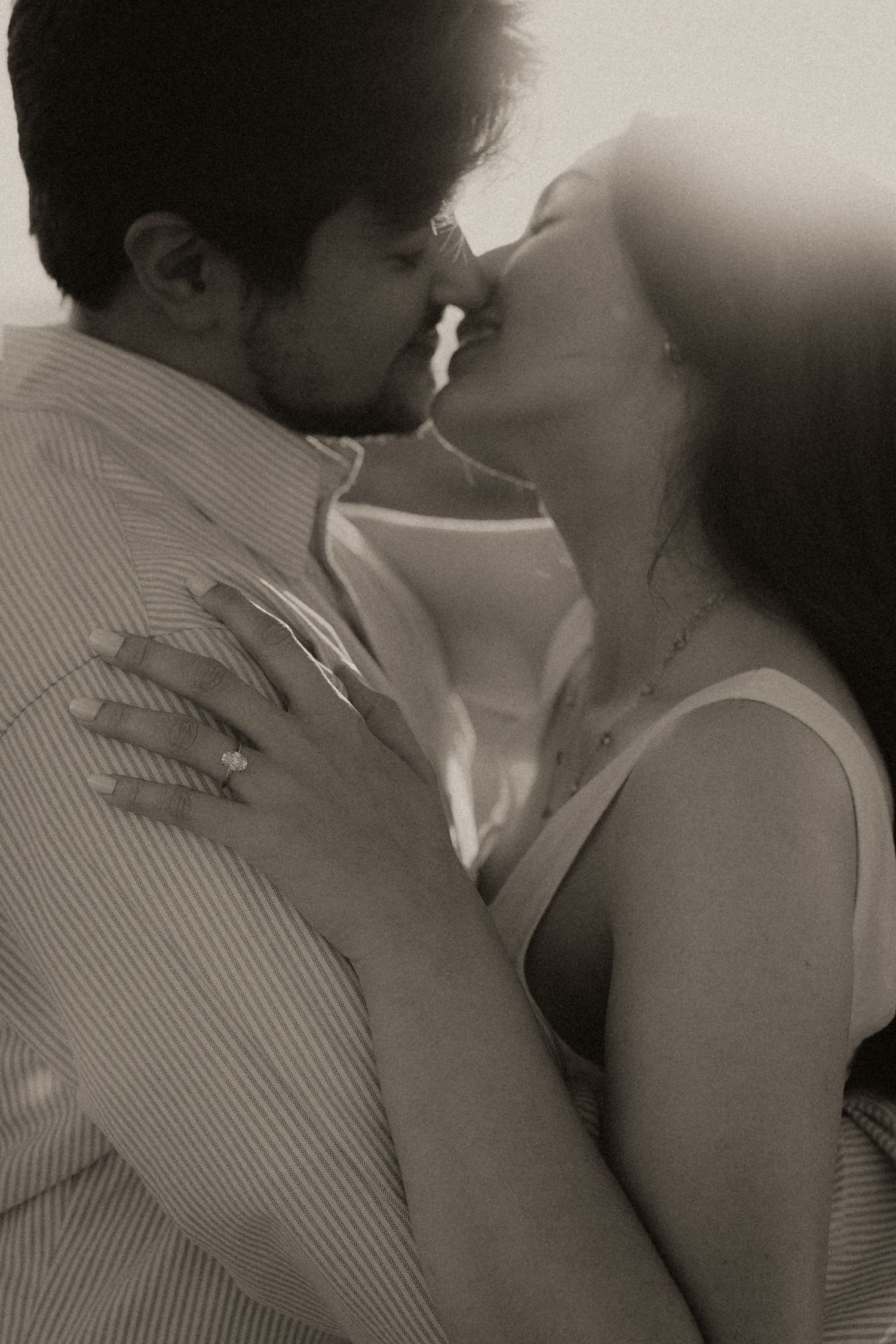 A series of romantic black and white photographs showing an intimate couple embracing and kissing.