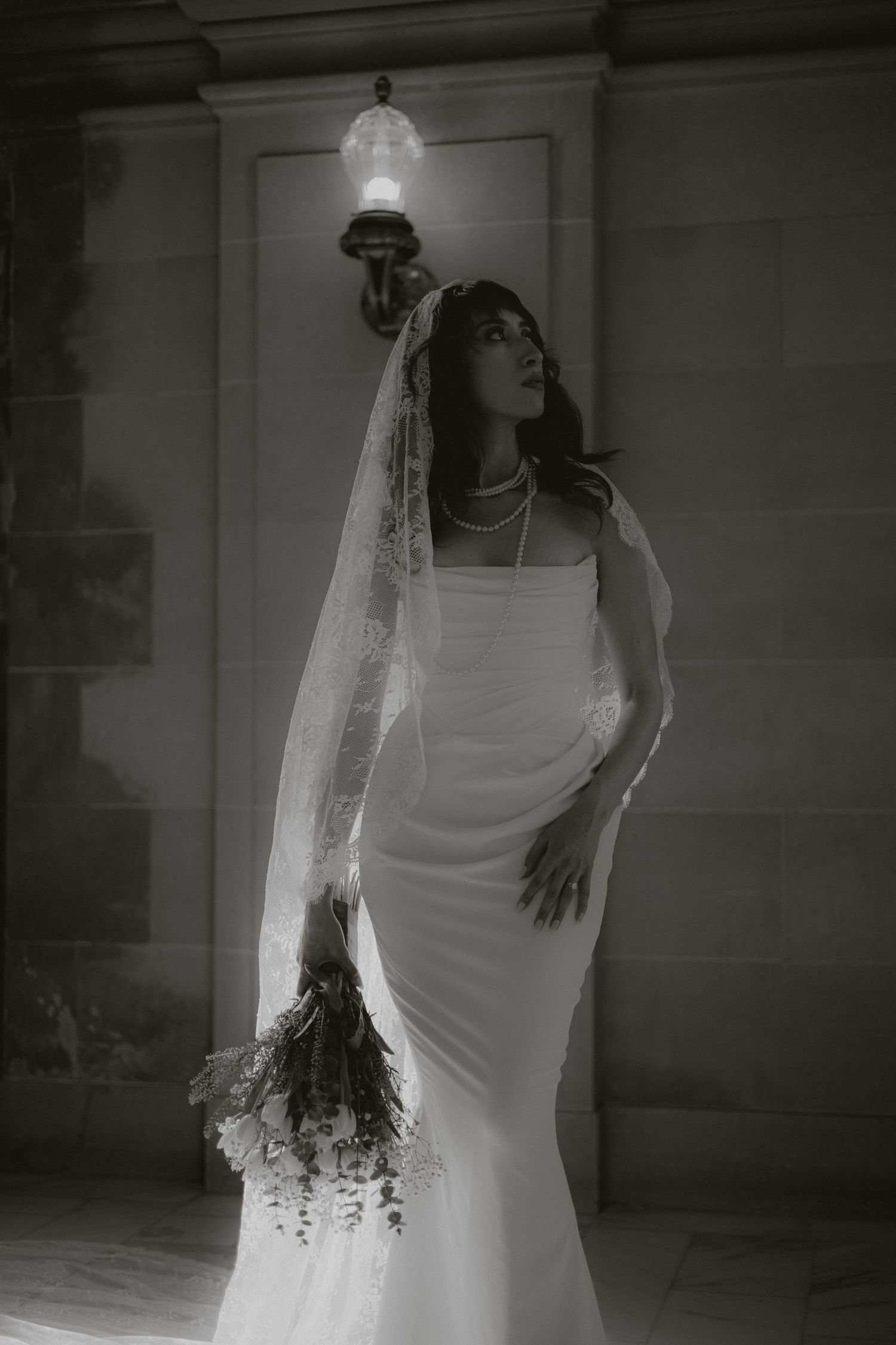 A bride in a white dress and veil poses dramatically in a moody black and white photoshoot sequence.