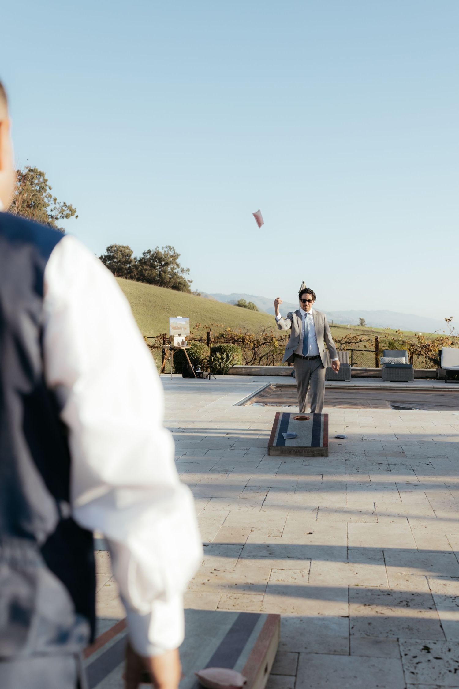 Outdoor wedding venue with stone pavers and scenic mountain views on a clear sunny day.