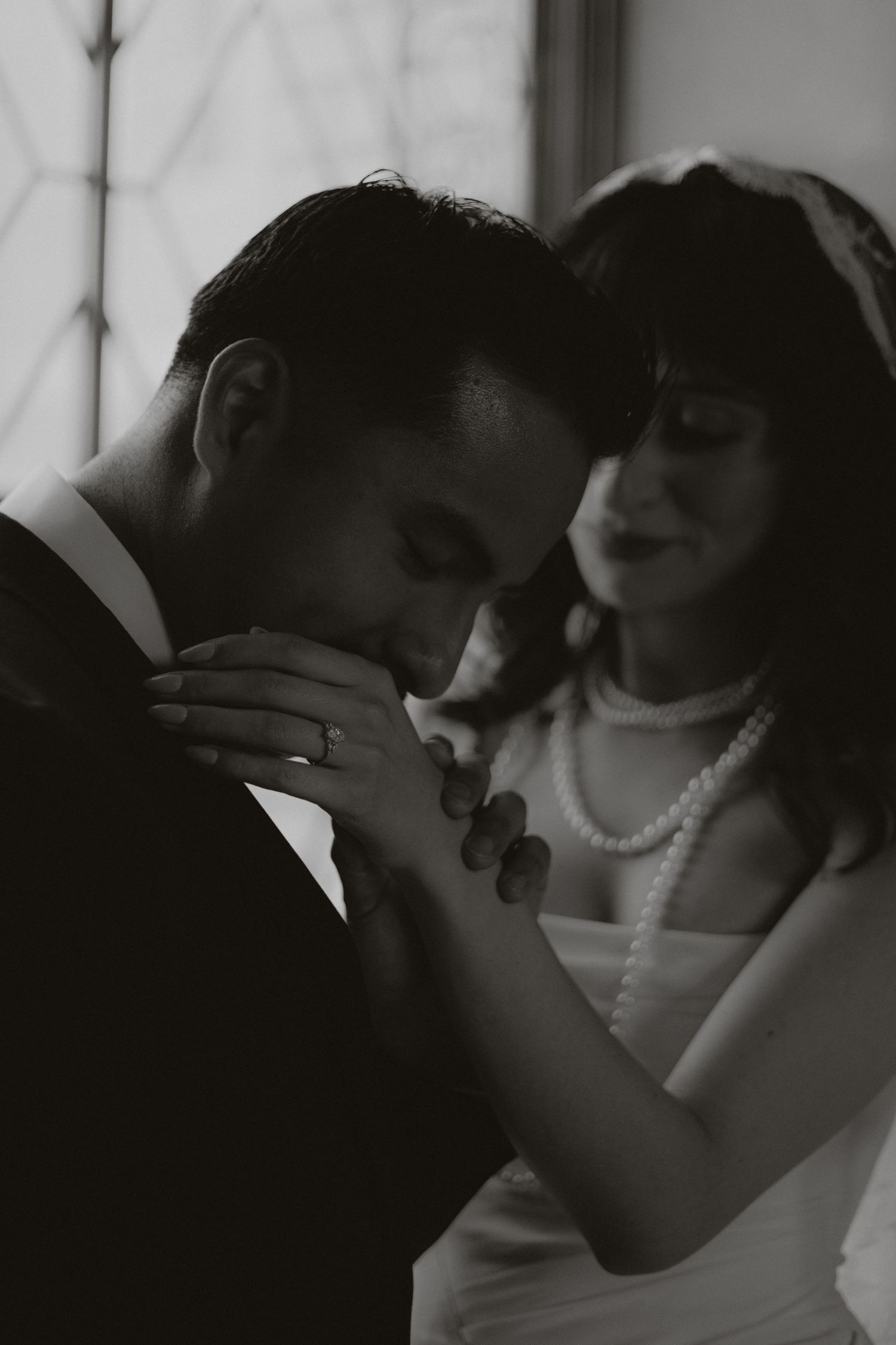 A romantic black and white photo series showing a couple in an intimate embrace wearing formal attire.
