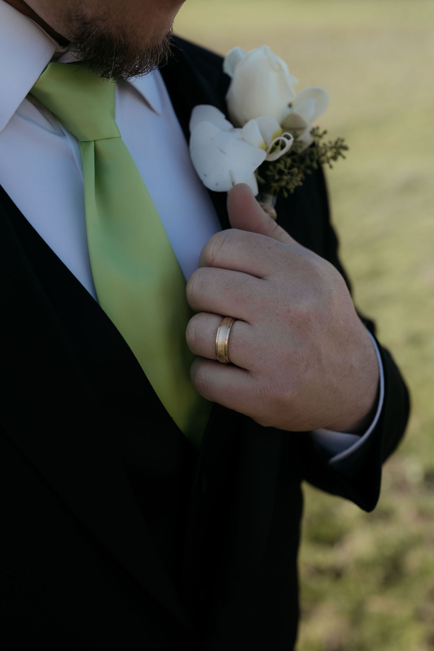 Close-up sequence of hands wearing wedding rings against a green background.