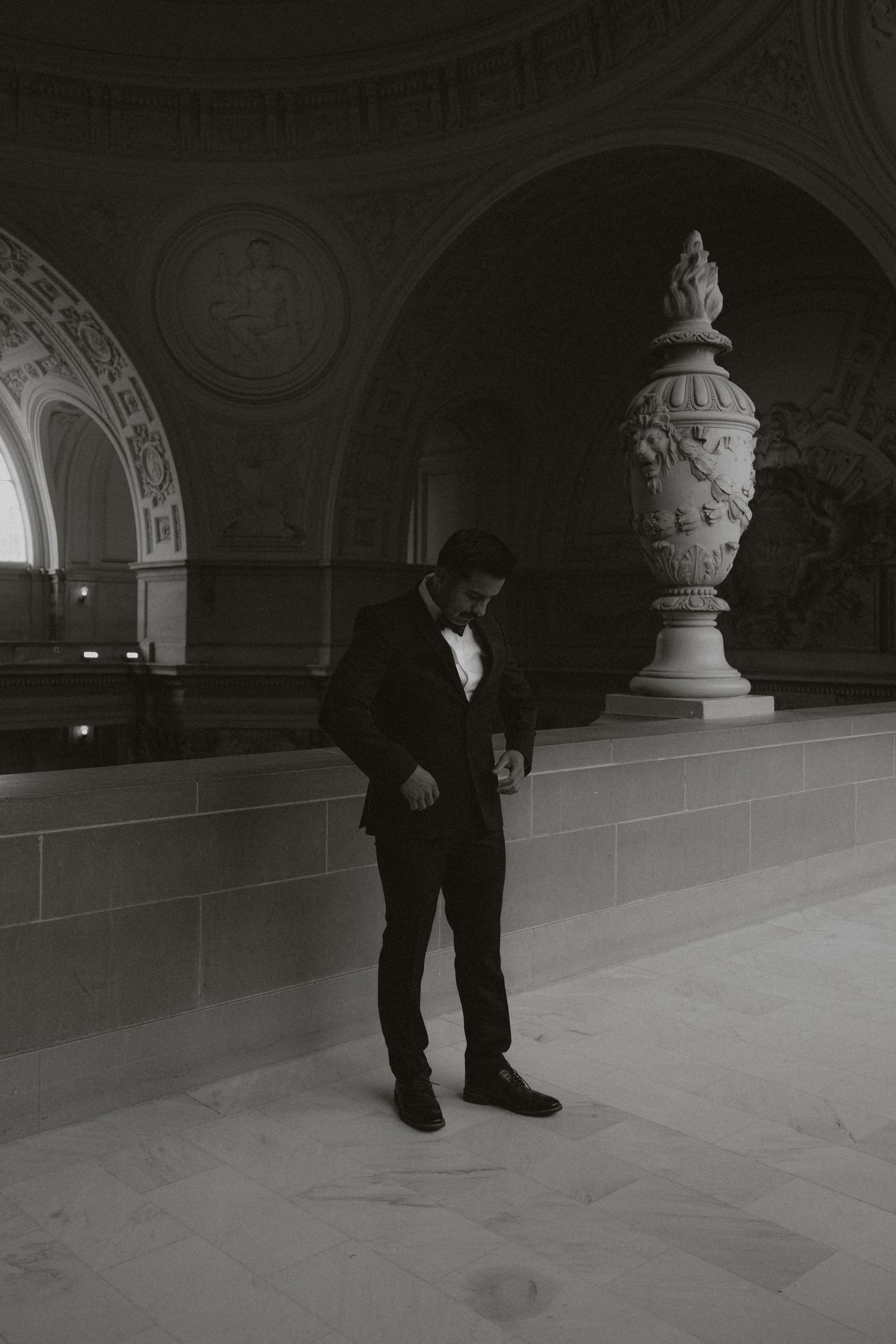 A series of black and white photographs showing a person's legs and feet walking across a grand interior space.
