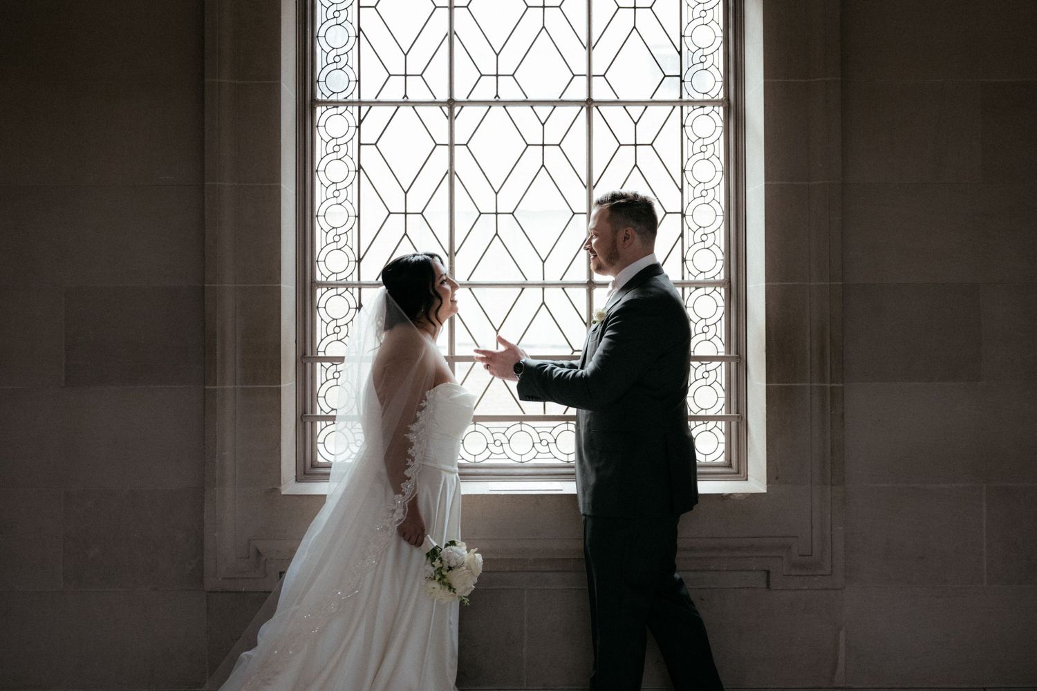 A romantic silhouette of newlyweds stands before ornate church windows in a series of artistic wedding photos.