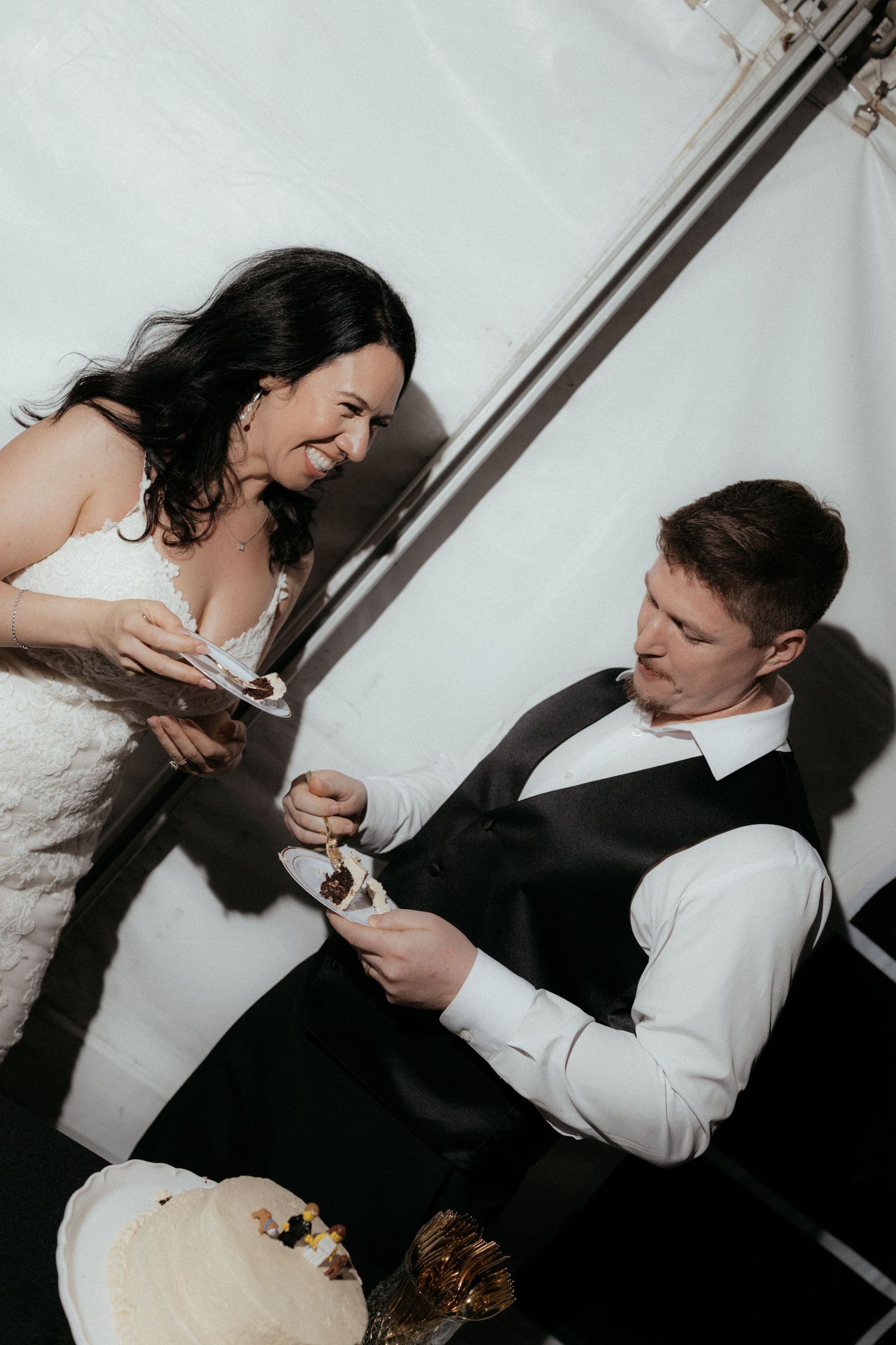 A sequence of playful wedding photos showing a couple sharing cake during their reception celebration.