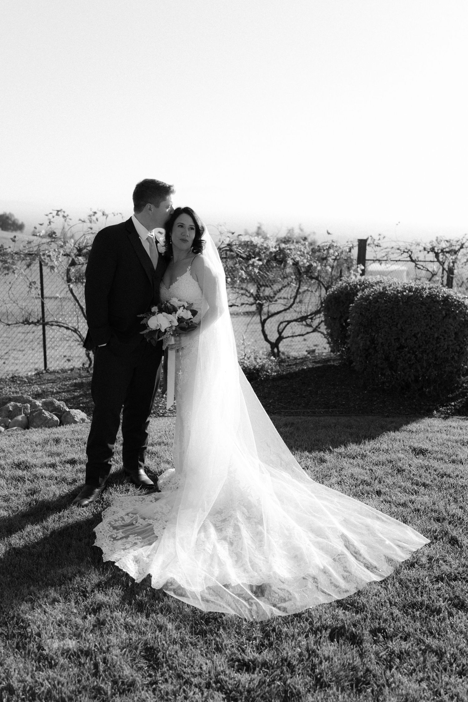 A romantic black and white wedding photo sequence showing a couple in an outdoor field setting.