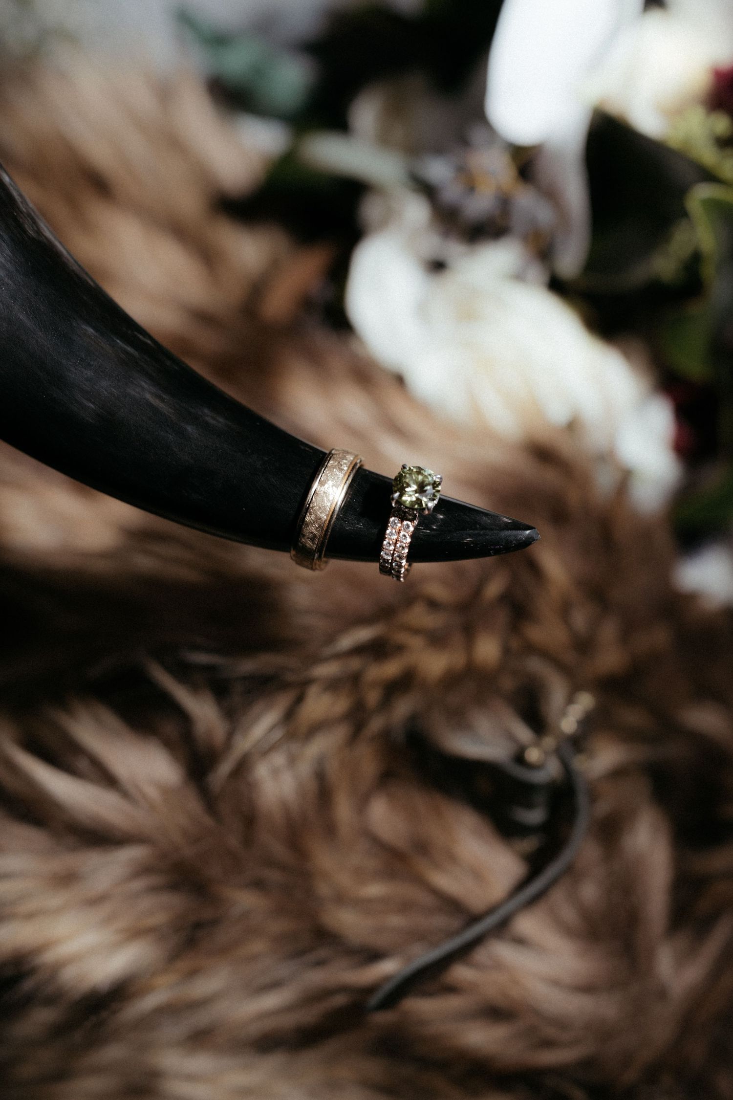 Close-up of elegant wedding rings with diamond details against a textured background.